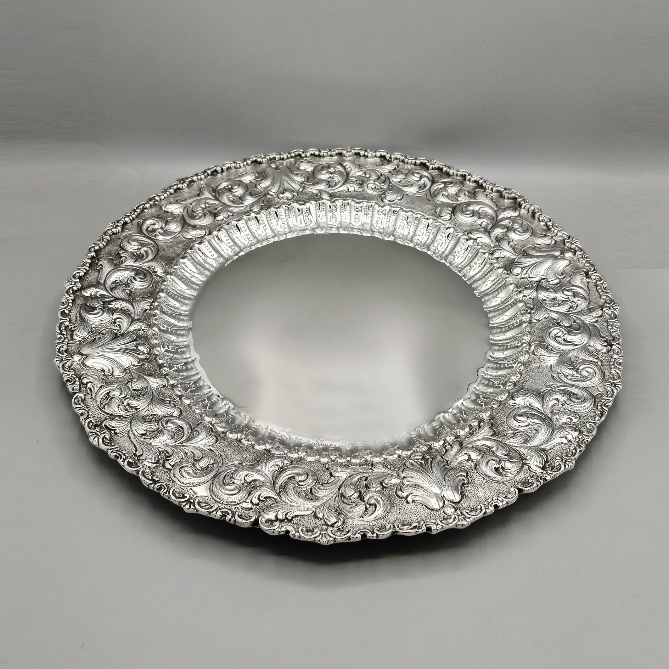 Baroque-style solid 800 silver plate.
The plate was entirely handcrafted from a sheet of 800 silver. It was hammered and finely embossed and chiseled with scrolls, typical of the Baroque style.
The edge was cast and soldered to the outside of the