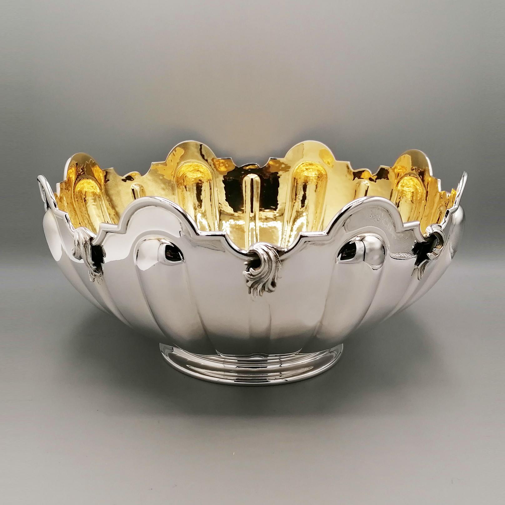Monteith centerpiece in Sterling silver internally plated in 24kt gold. 
A flat border was welded onto the jagged upper edge as a finish. 
Also on the upper edge, spiral inserts made with the fusion technique were welded. 
The body was embossed