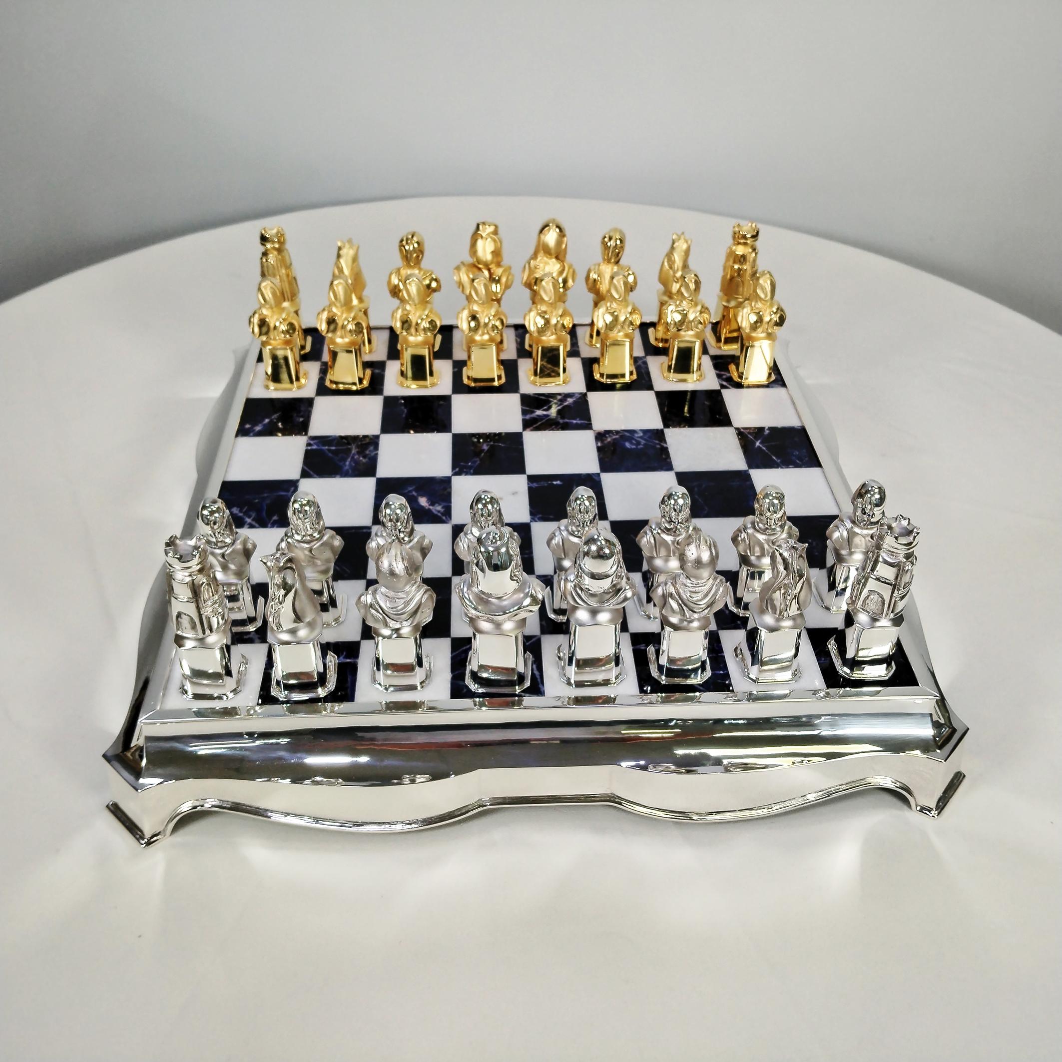 Solid sterling silver chessboard with a chess game inspired by the works of sculptor De Chirico. Sodalite top.
The chess set features a silver finish for one player, while the other player has a 24kt gold-plated silver finish. To give the pieces