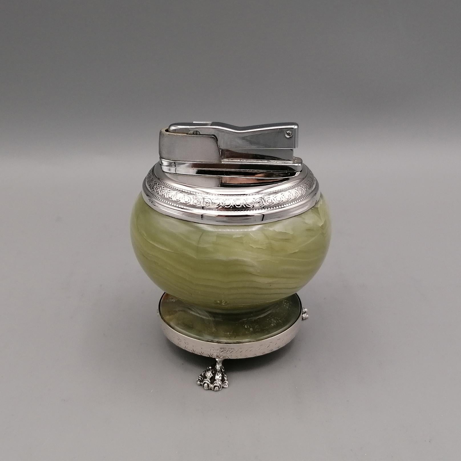 Lighter made in Italy in the late 60s. 
The body is round and in cerde onyx with yellow ocher details.
The base is a smooth ring with a silver frame supported by 3 feet with a bird of prey paw design.
The upper part is always in smooth silver with a