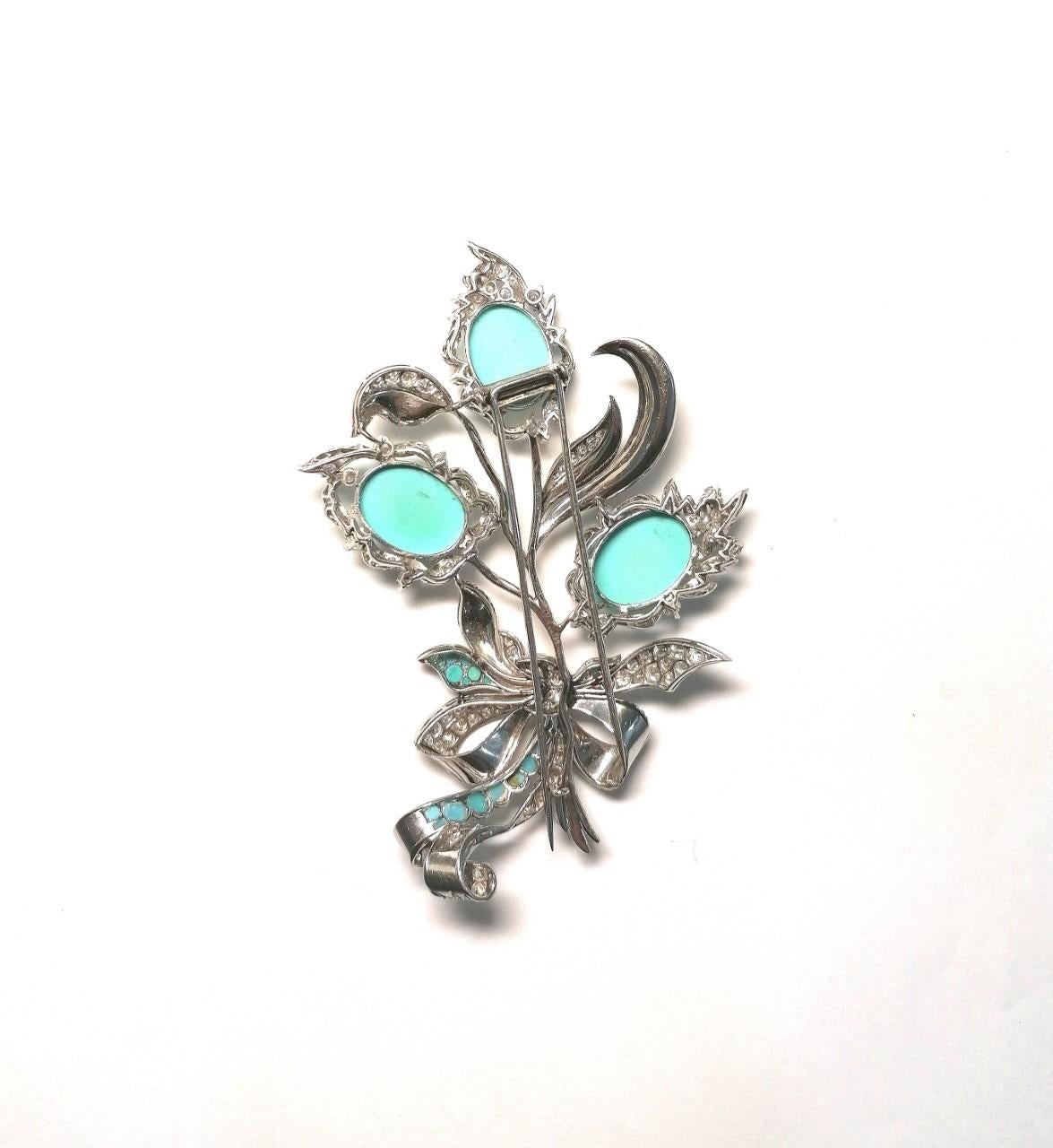 Magnificent vegetal-style platinum brooch with natural turquoise cabochons and brilliant-cut diamonds. Weighing approximately 9 carats. Color and clarity, I - VS2. With two spikes. Total weight    grams.