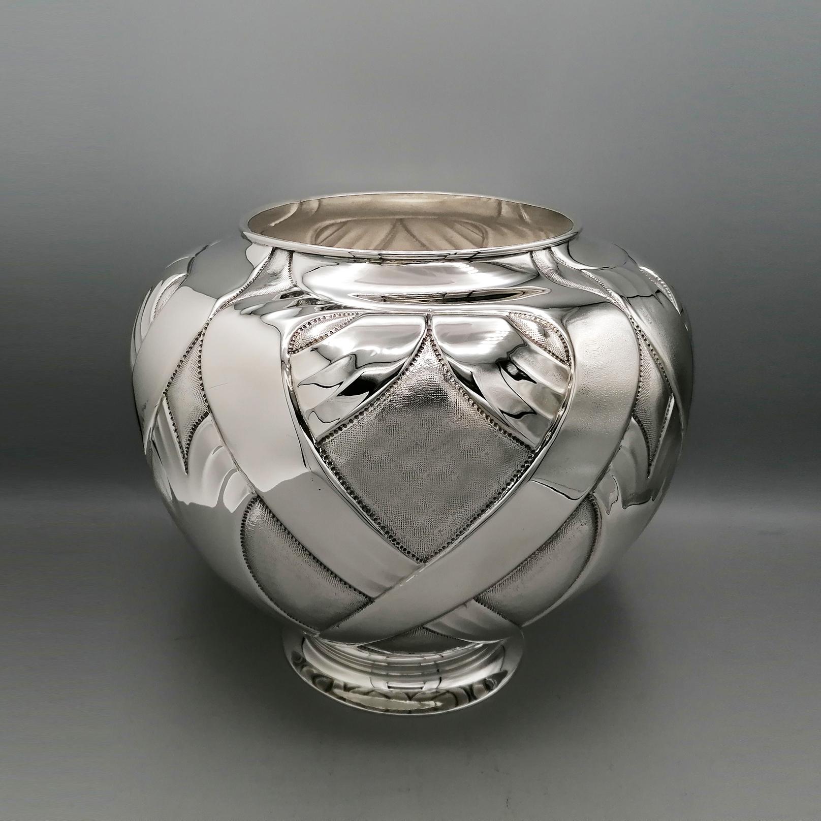 Modern 925 sterling silver vase.
The pot-bellied body has been embossed, chiselled and engraved with modern motifs, interspersed with fine knurling carried out to highlight the handwork.
A silver plate base was welded under the vase, left