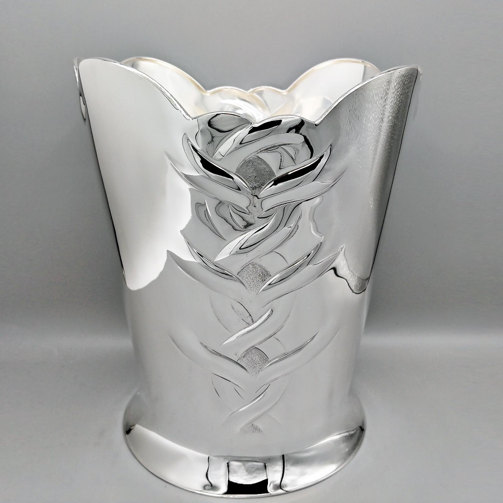 Sterling silver champagne bucket.
The bucket, completely handmade, is conical in shape with a widened base to allow stability on the support surface and blends perfectly with the body of the bucket.
The upper part of the object is shaped with a
