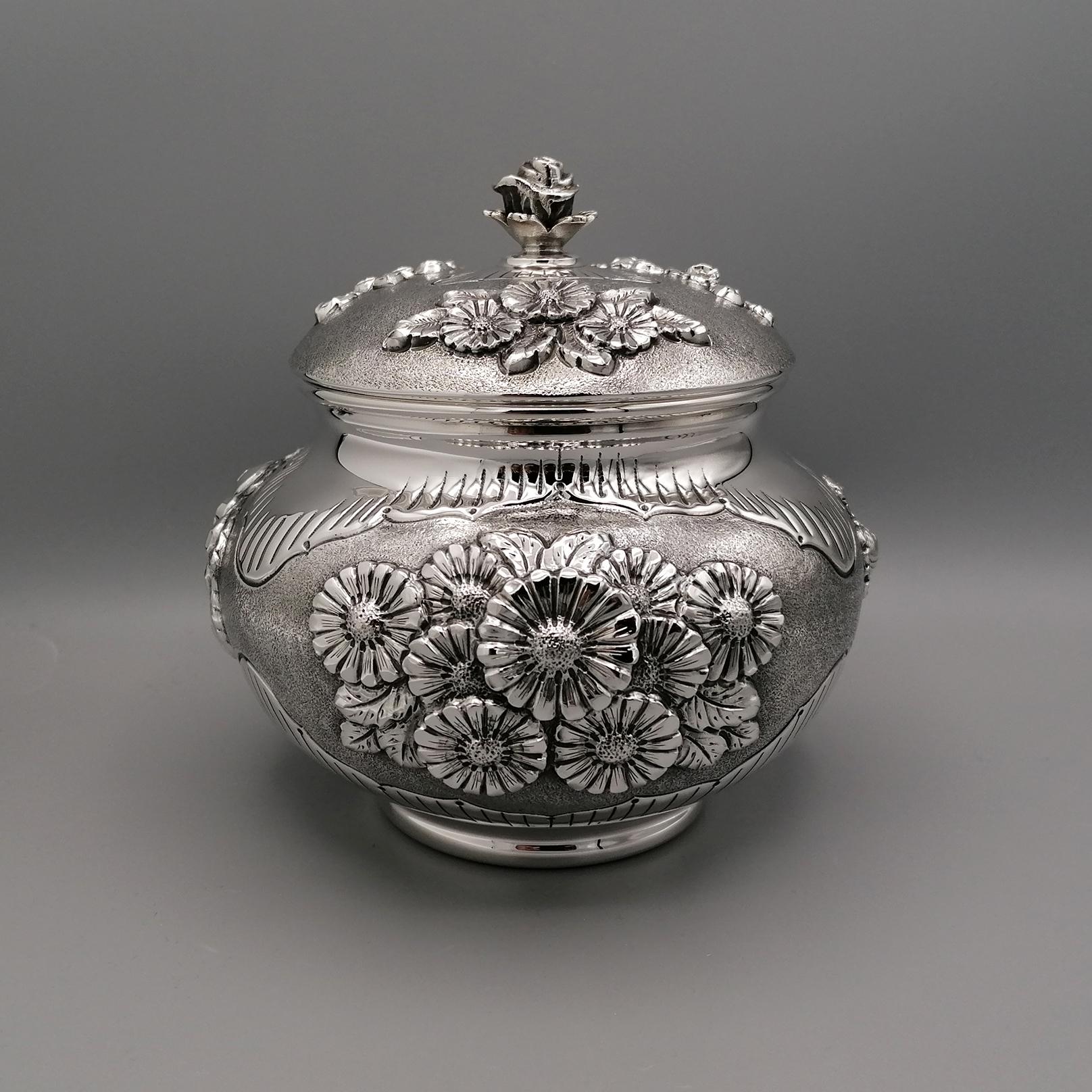 Completely handmade sterling silver candy box.
The box is round and pot-bellied.
Embossments and chisels of flowers were made all over the body.
The box is divided into three sectors, divided by different embossed flowers.
Daisies, Roses and