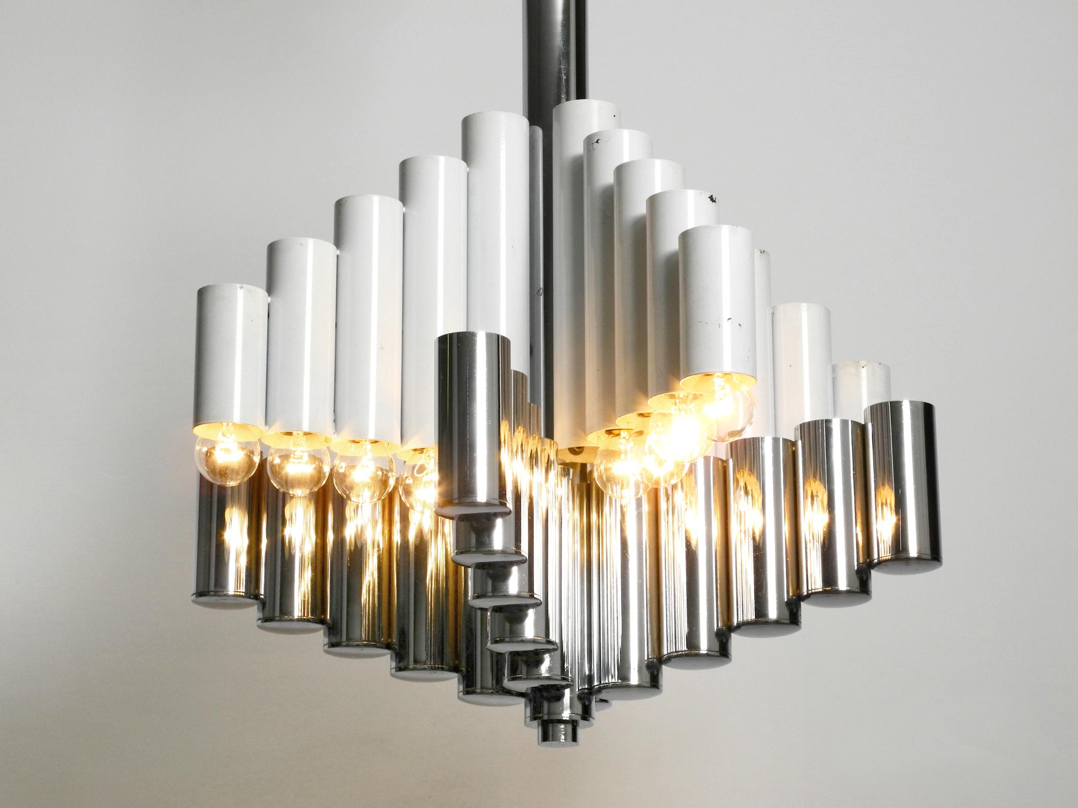 Very rare large heavy 1960s metal chandelier in Space Age Pop Art design. Very elegant ceiling lamp from an italian production. Attributed to Gaetano Sciolari.
Metal tubes in different heights, which are painted white at the top, and are