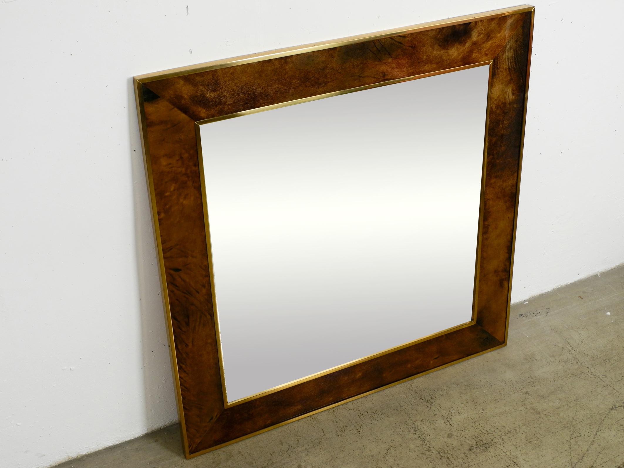 Original extra large 1970s wall mirror by Aldo Tura made of brass and leather.
Great Italian design. Made in Italy. With original label on the back.
Frame is made of brass and goat leather coated with transparent lacquer.
Back is made of