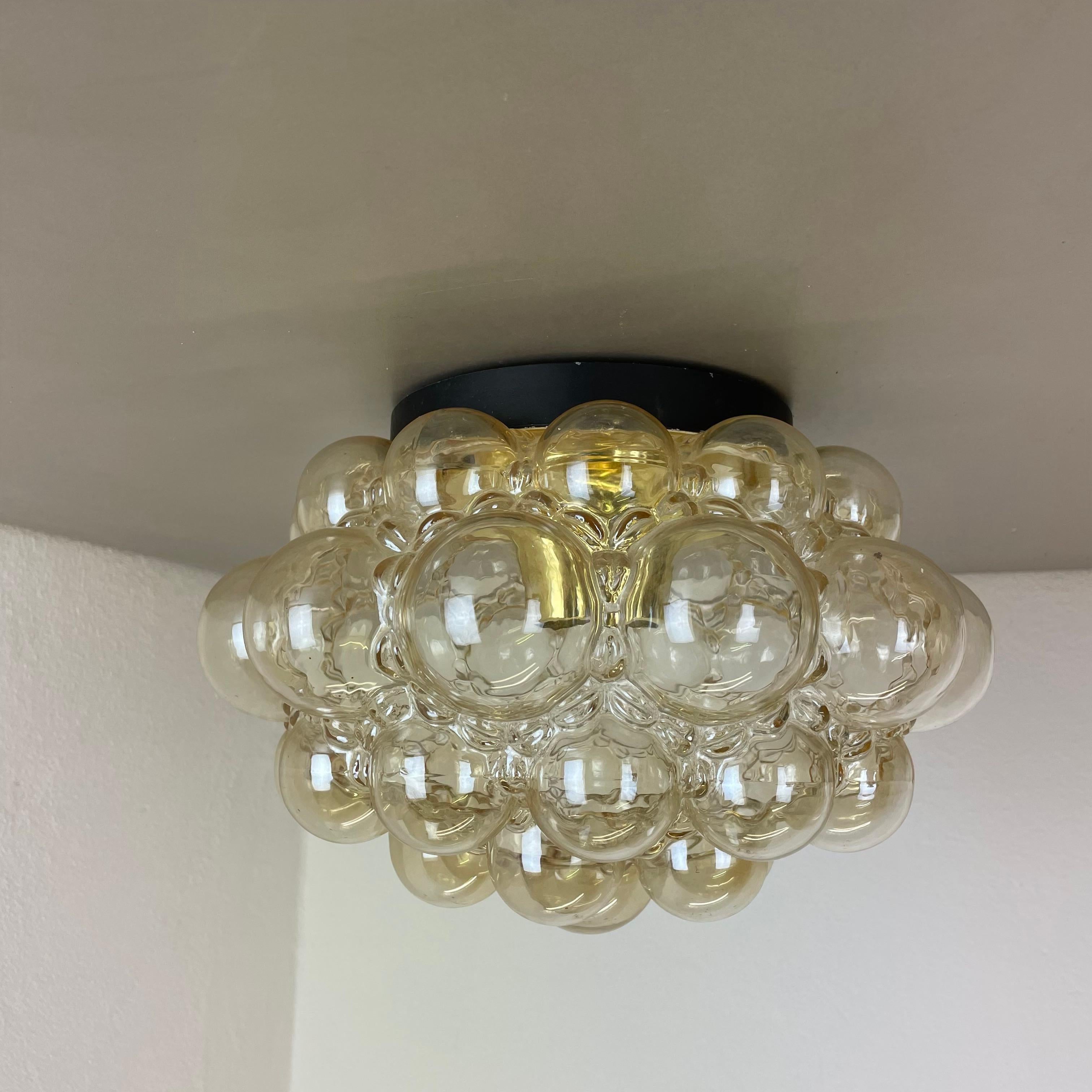 Article:

wall light  ceiling light



Producer: 

Glashütte Limburg, Germany


Design:

Helena Tynell


Origin: 

Germany


Age: 

1970s





This fantastic glass ceiling light was designed by Helena Tynell and produced in 1960s in Germany by