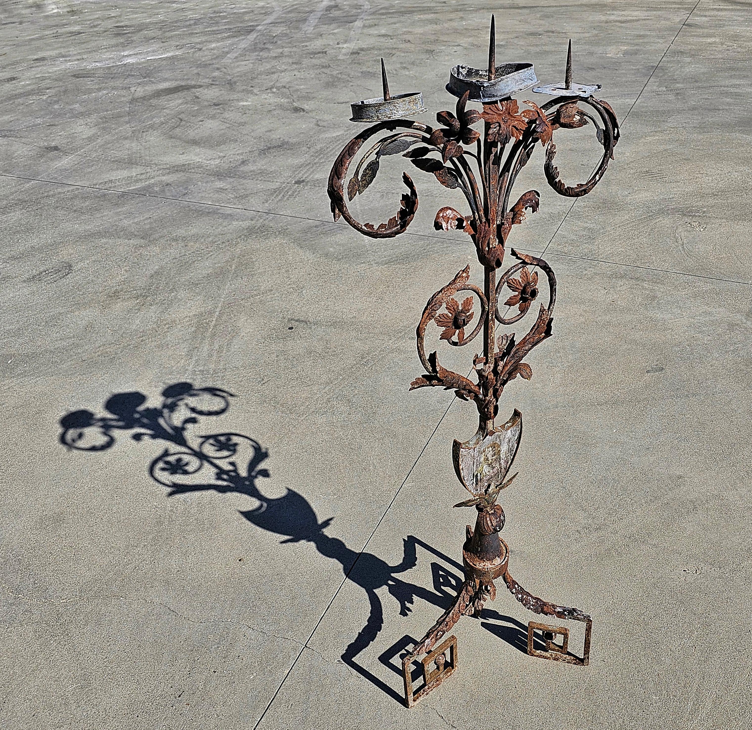 In this listing you will find a unique Baroque 3-arm candelabra done in wrought iron. It features a small fresco of Saint Joseph holding a white lily. The candelabra is rich in floral ornament, namely the flower and the acanthus leaves. Candelabra