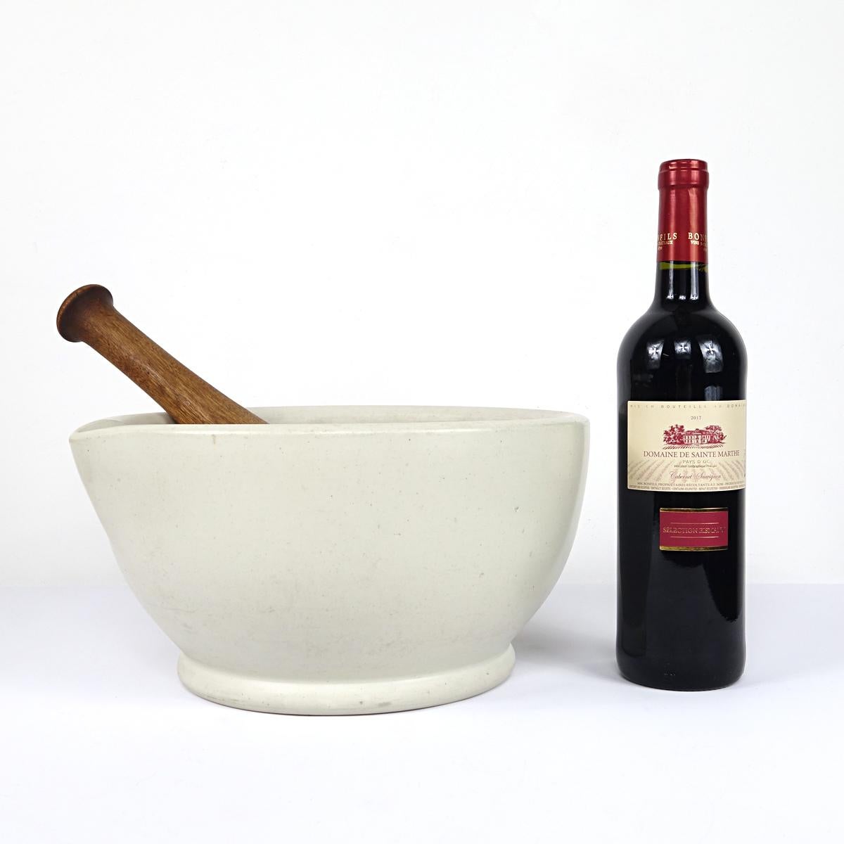 Extra large porcelain mortar with pestle made of porcelain and wood. 
A wonderful accent piece in your kitchen. The mortar is very heavy and solid. 

Dimensions mortar:
Height 15.5 cm (6.1 inch), length 30.5 cm (12 inch), width 29 cm (11.4