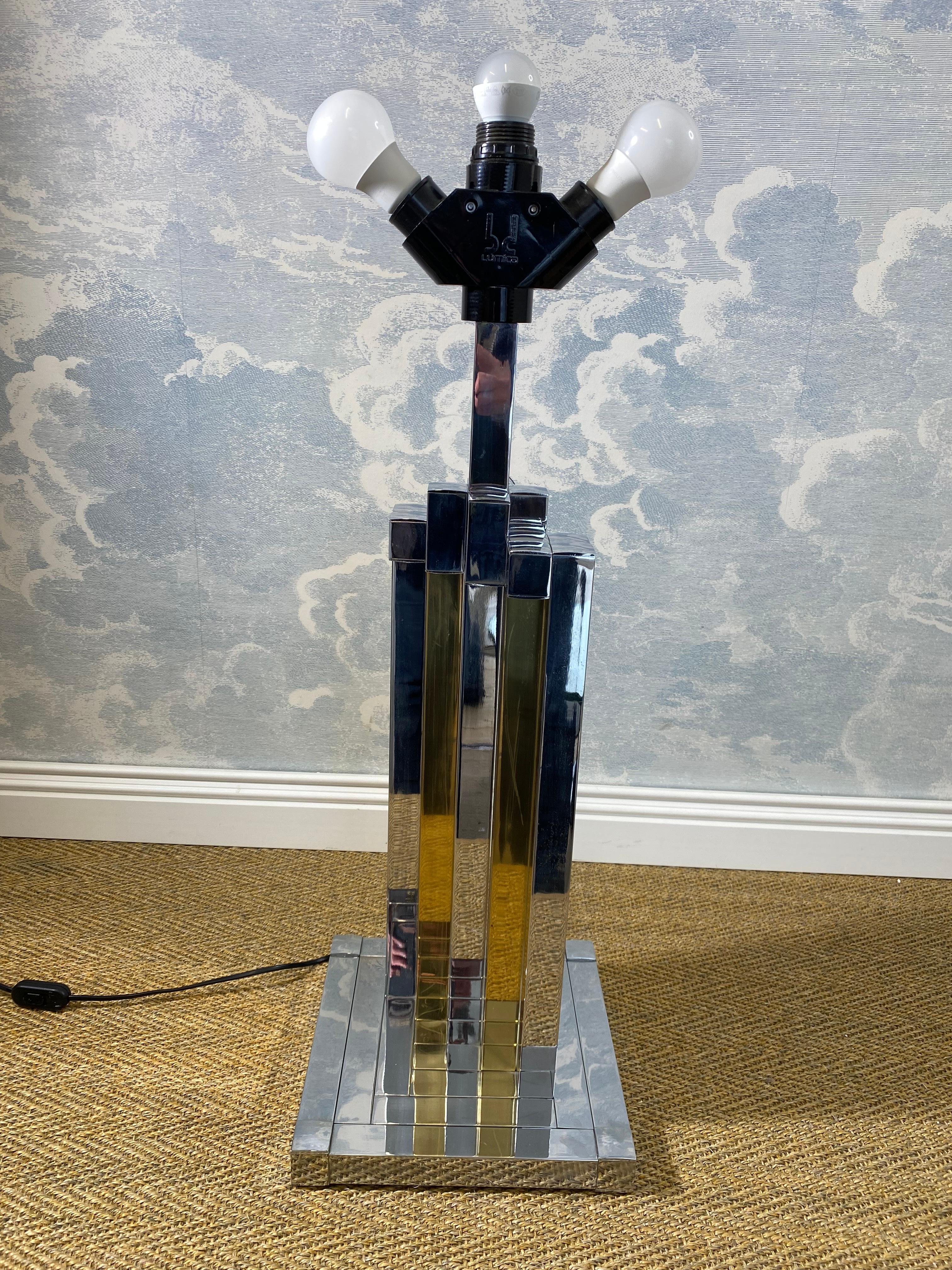 This rather large table lamp is made from polished brass and chromed tubes and was created in Spain by the prominent lighting manufacturer bd Lumica.

In very good condition with almost no signs of its age and use, this is an eye-catching statement