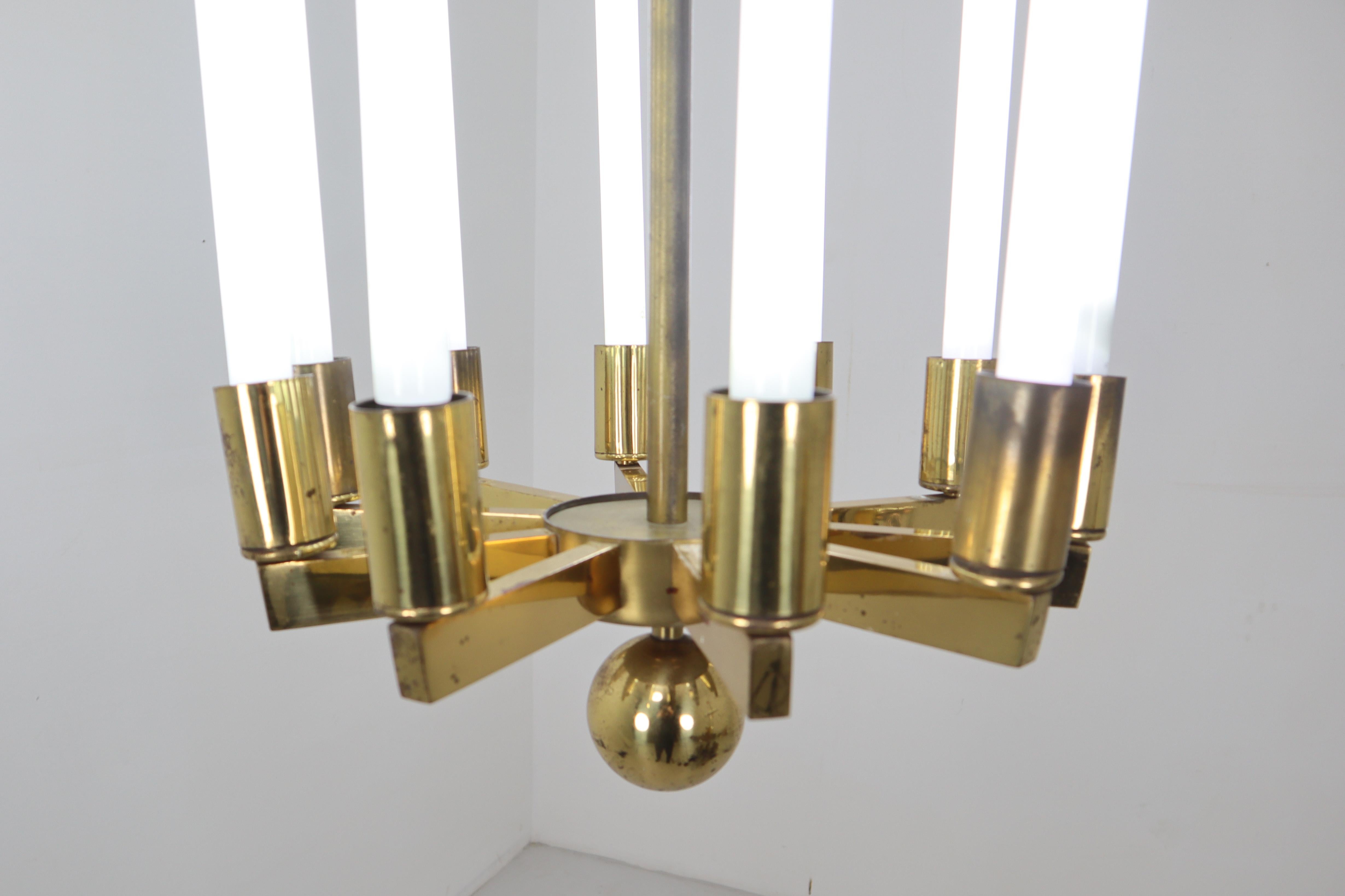 Extra large brass chandelier by Kaiser & Co., made in Germany, circa 1940s. In the fashion of Art Deco transitioning into modern and Bauhaus. Patinated brass frame supports ten fluorescent tubes. It makes a beautiful ceiling pendant light for spaces