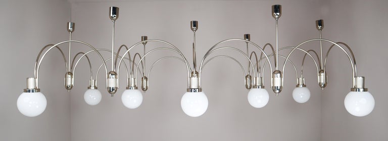 Mid-Century Modernist extreme large chandelier with hand blown opaline glass globes. A warm and diffuse light will create a stunning light partition. This chandelier will contribute to a luxurious character of the (hotel-bar) interior. Fitted with a