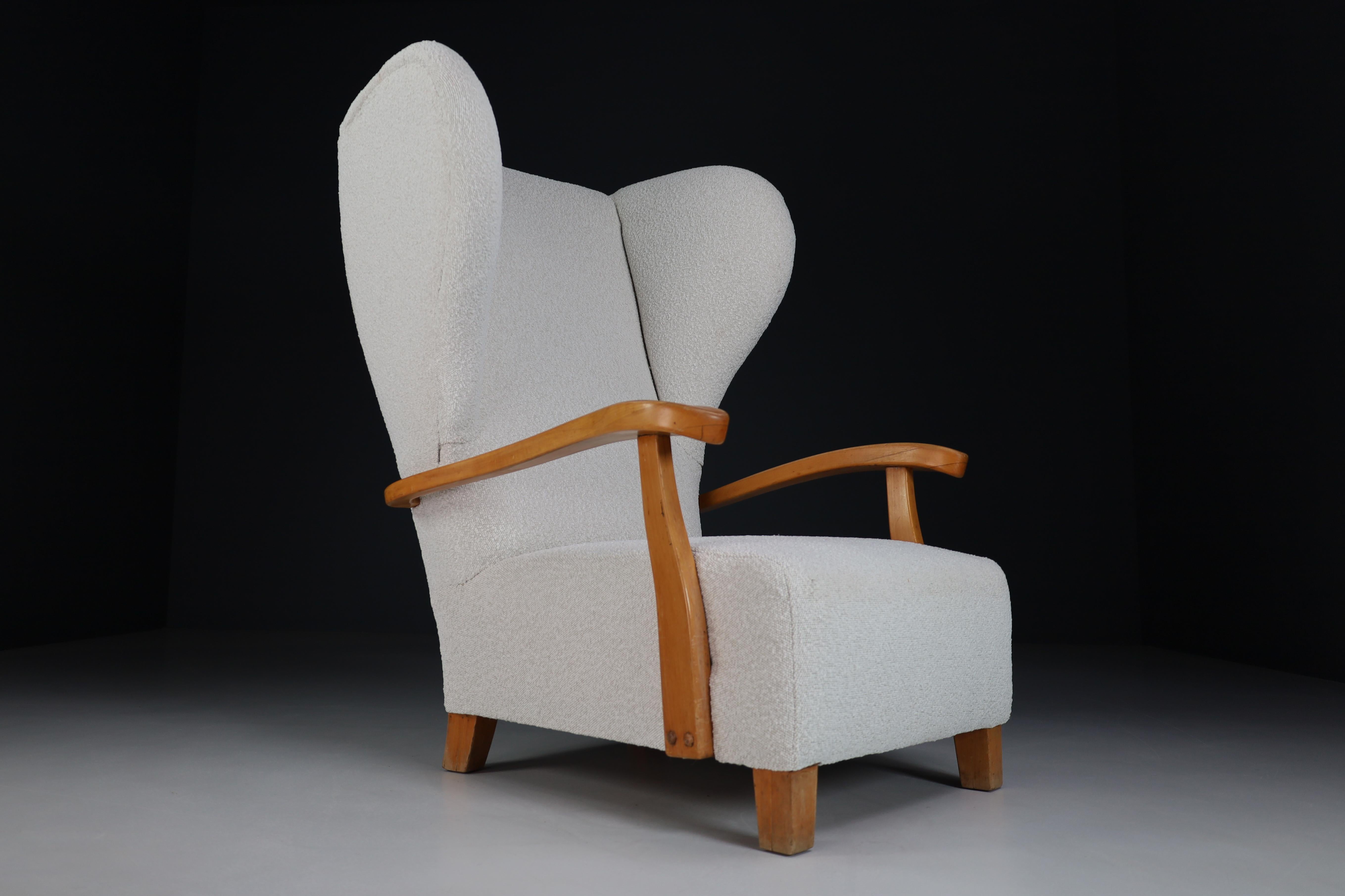 Large monumental midcentury wingback armchair in walnut and re-upholstered bouclé fabric, France 1930s. This monumental Xl size armchair - lounge chair would make an eye-catching addition to any interior such as living room, family room, screening