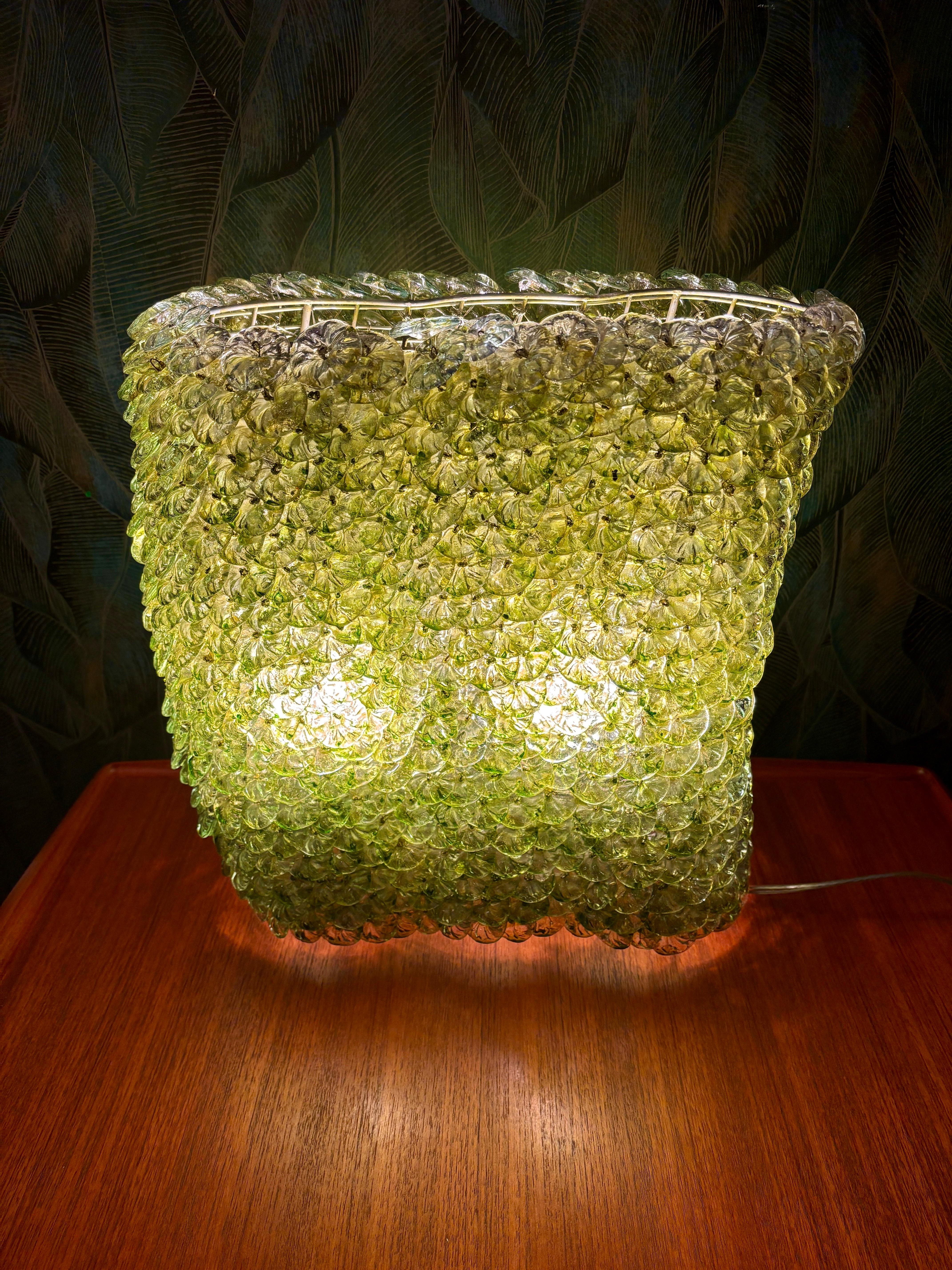 Rare and very old Murano glass table lamp with 1,000 green glass blossoms.
The lamp is very solid and heavy. The glass blossoms are in very good condition and all are present (5 spare glass blossoms included).
The base is made of metal wire.

Height