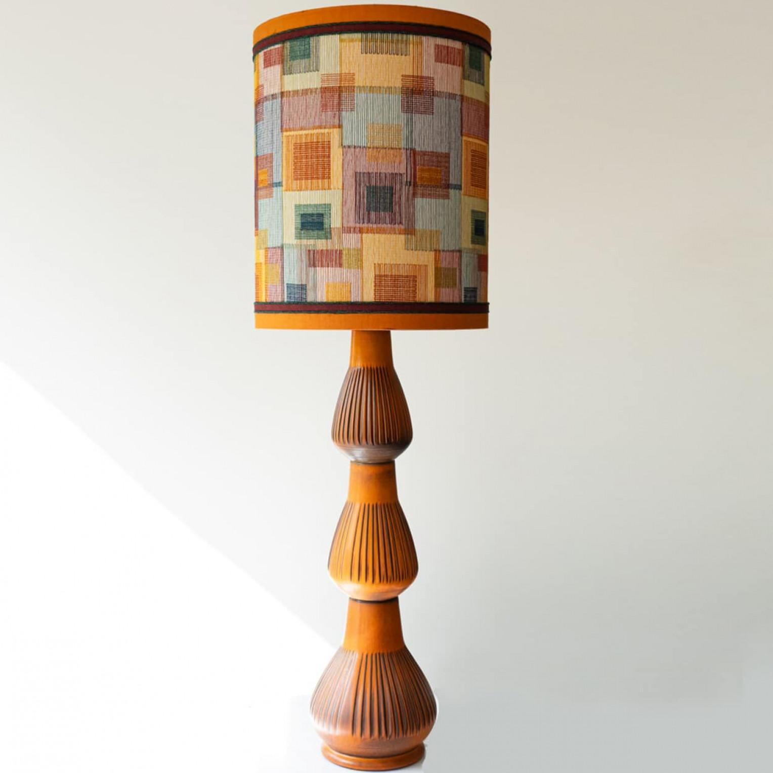 Heavy quality ceramic  floor lamp, 1970s.

This  lamp base brings playful elegance and rich visual appeal to any interior. With its beautiful shape, it offers a unique presence.

This base with orange shades fits perfectly with the custom made multi