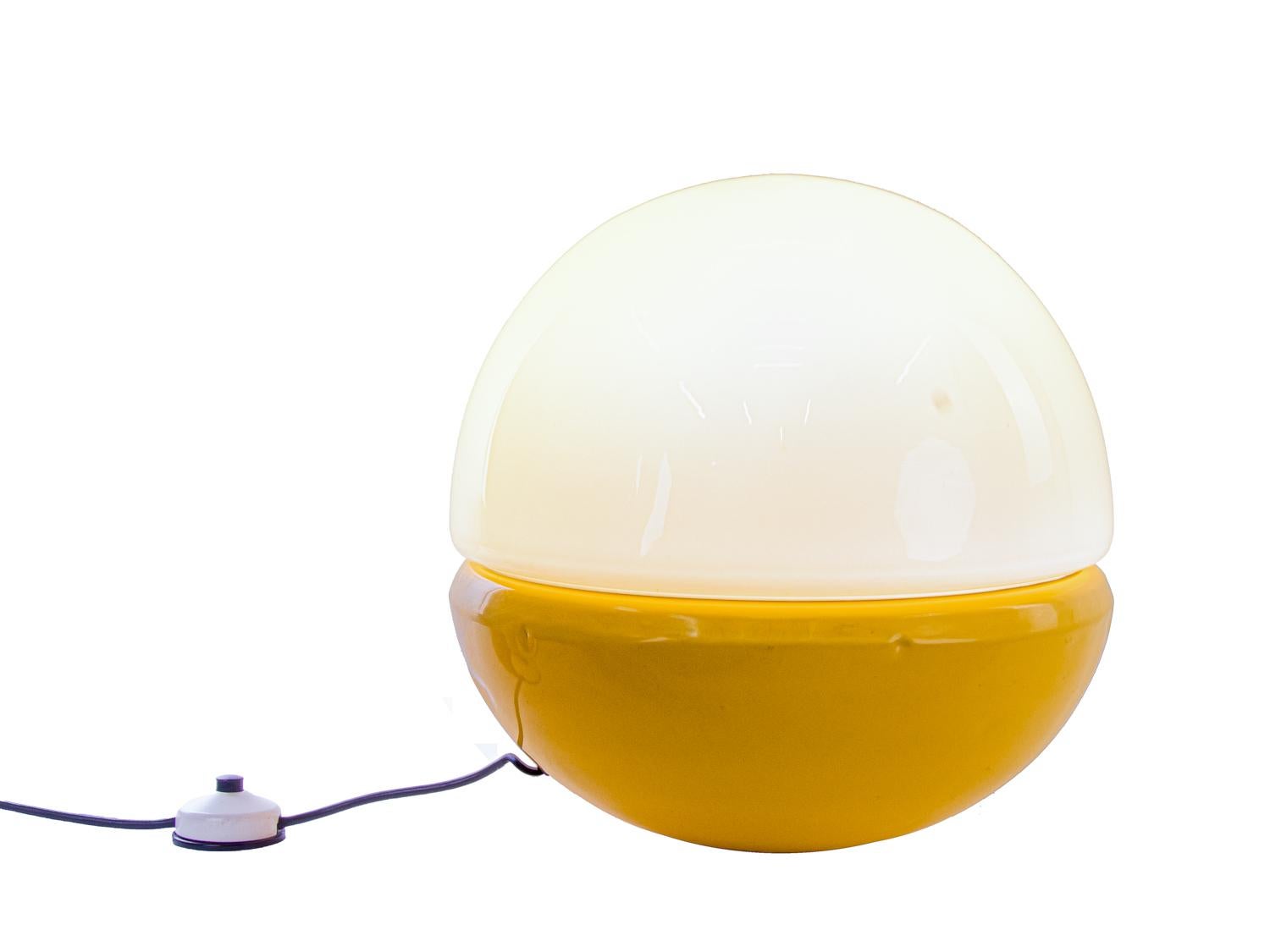 On offer is an extremely rare, breathtaking XL Pop Art floor or table lamp, consisting of a weighted hemisphere made of lacquered metal in yellow-orange and a hemisphere made of white hand-blown Murano glass, which was manufactured in Germany in the