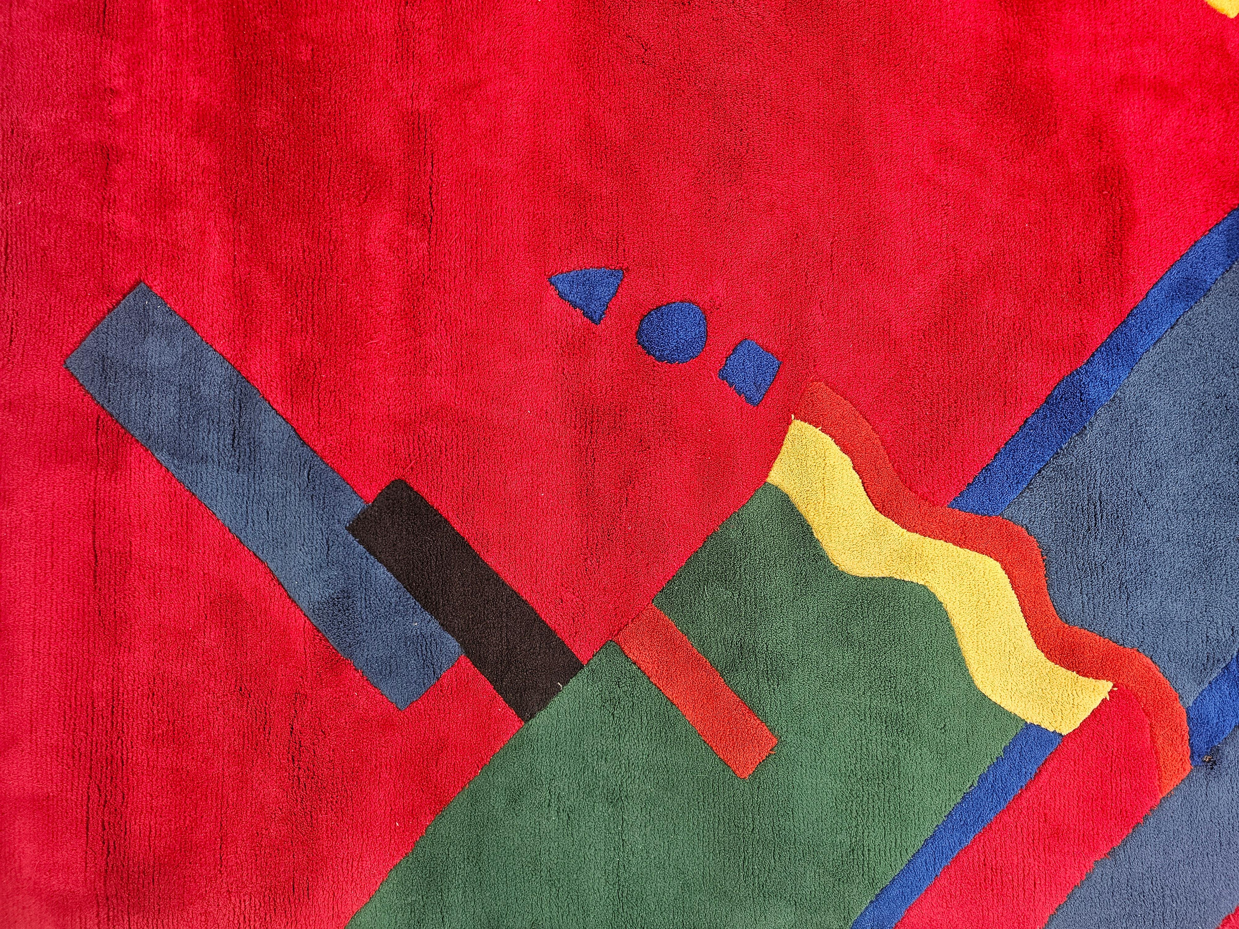 In this listing you will find a breathtaking XXL hand-tufted postmodern. It is designed in style of Memphis Milano, featuring vibrant geometric pattern in red, blue, green, black and yellow. This playful rug will be a perfect addition to larger