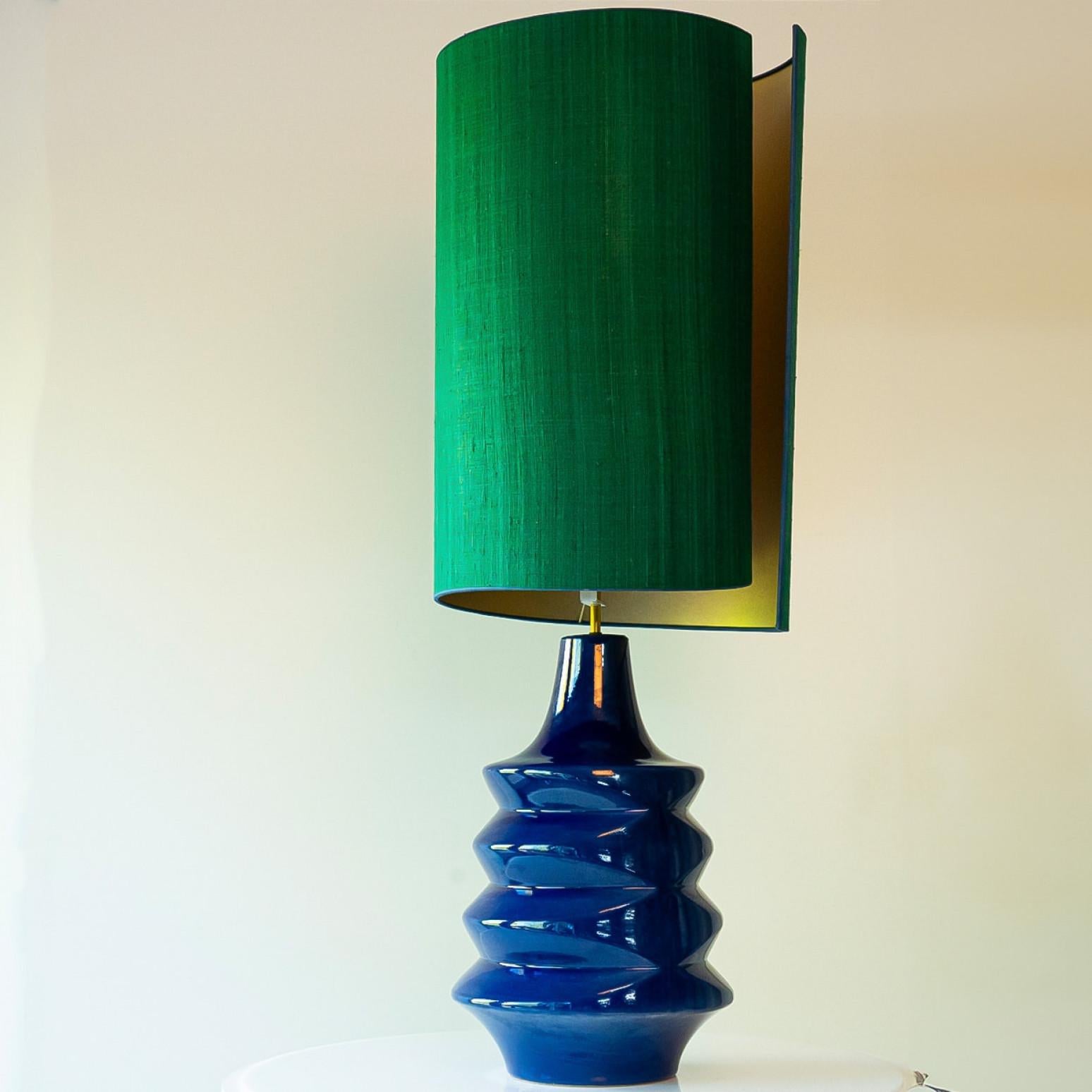 Heavy quality ceramic floor lamp, 1970s.

This  lamp base brings playful elegance and rich visual appeal to any interior. With its beautiful shape, it offers a unique presence.

This base with Sapphire blue shades fits perfectly with the custom made