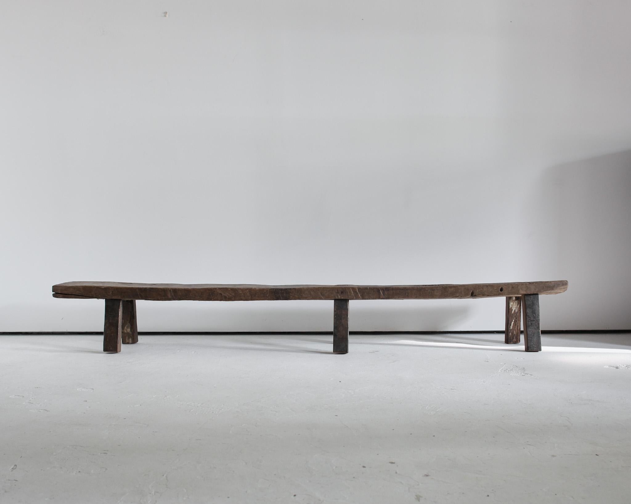 A very large Primitive 18th century. Bench from Navarra, Spain.
Constructed from one 7cm thick handcut slab of oak.
Heavily patinated with many age old repairs and later feet.