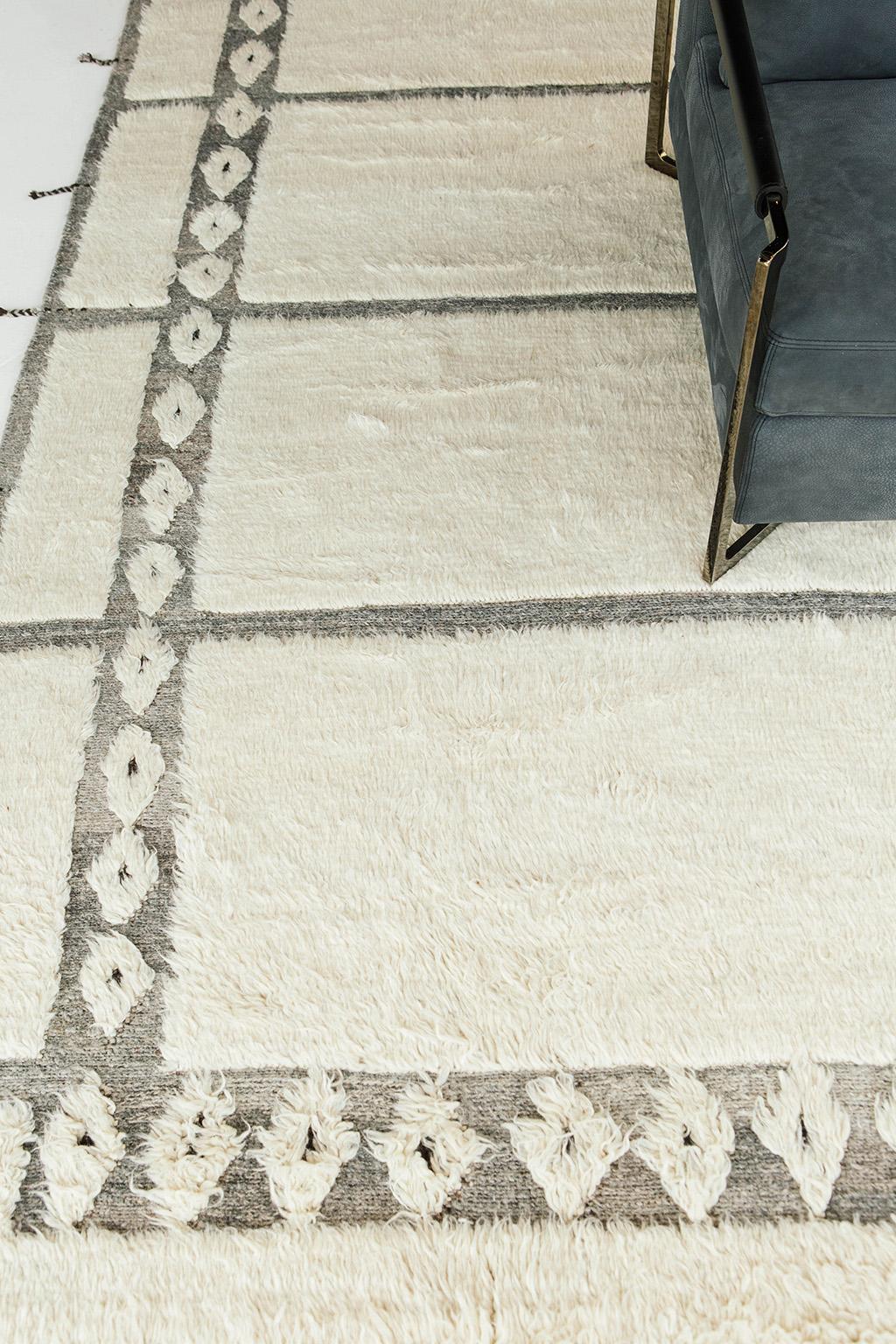 Natural grey flat-weave and white wool shag create structured rectangular embossed designs with a diamond border. Designed in Los Angeles for the coastal community, Xxlok was handwoven with extreme detail and can withstand high foot traffic. This