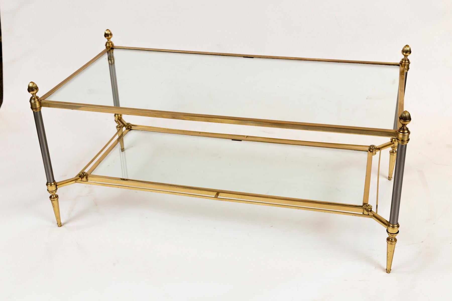Modernized classic Maison Jansen solid brass table with matte nickel legs, two-tier rectangular shaped low table  finishing with acorn toupie embellishments
Dating: 1960ca
Origin: France
Condition: Excellent repolished condition (note the photos
