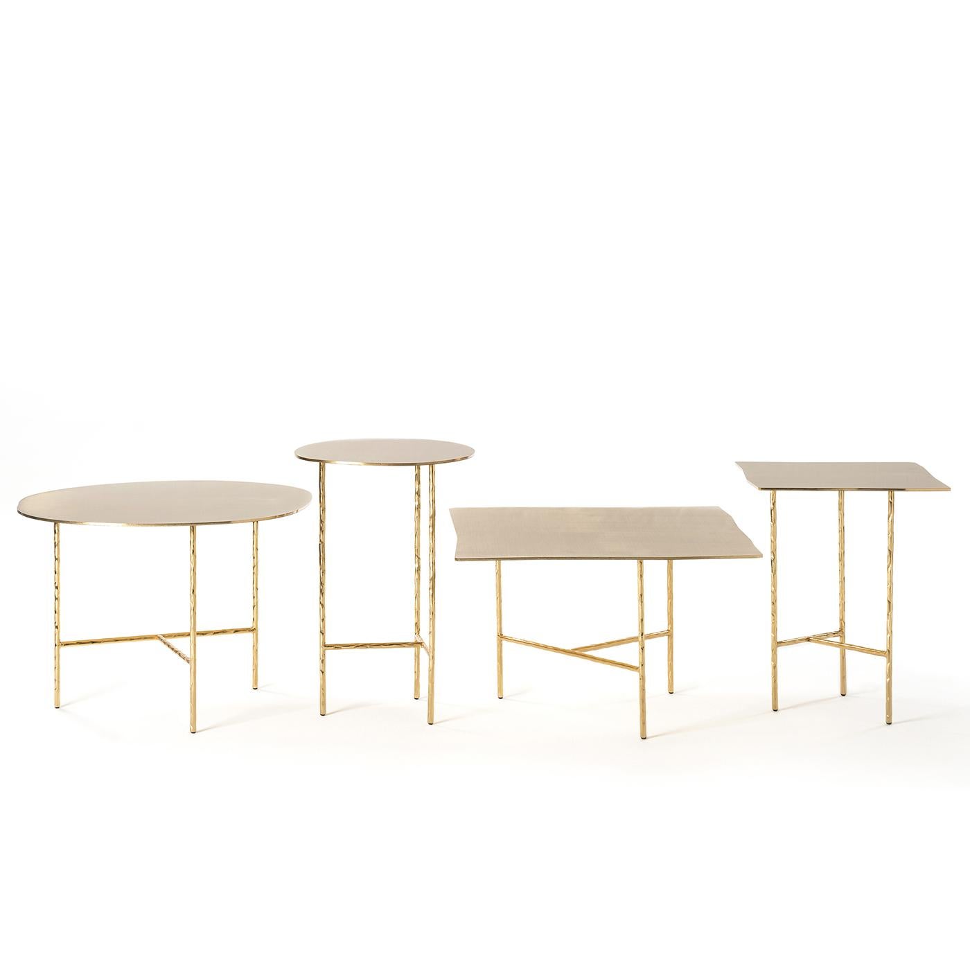 The XXX series of tables designed by Lapo Ciatti is defined by the striking contrast between the perfectly polished finish and the imperfectly shaped silhouette that makes them unique. Crafted of stainless steel with a 24-karat gold-plated finish,