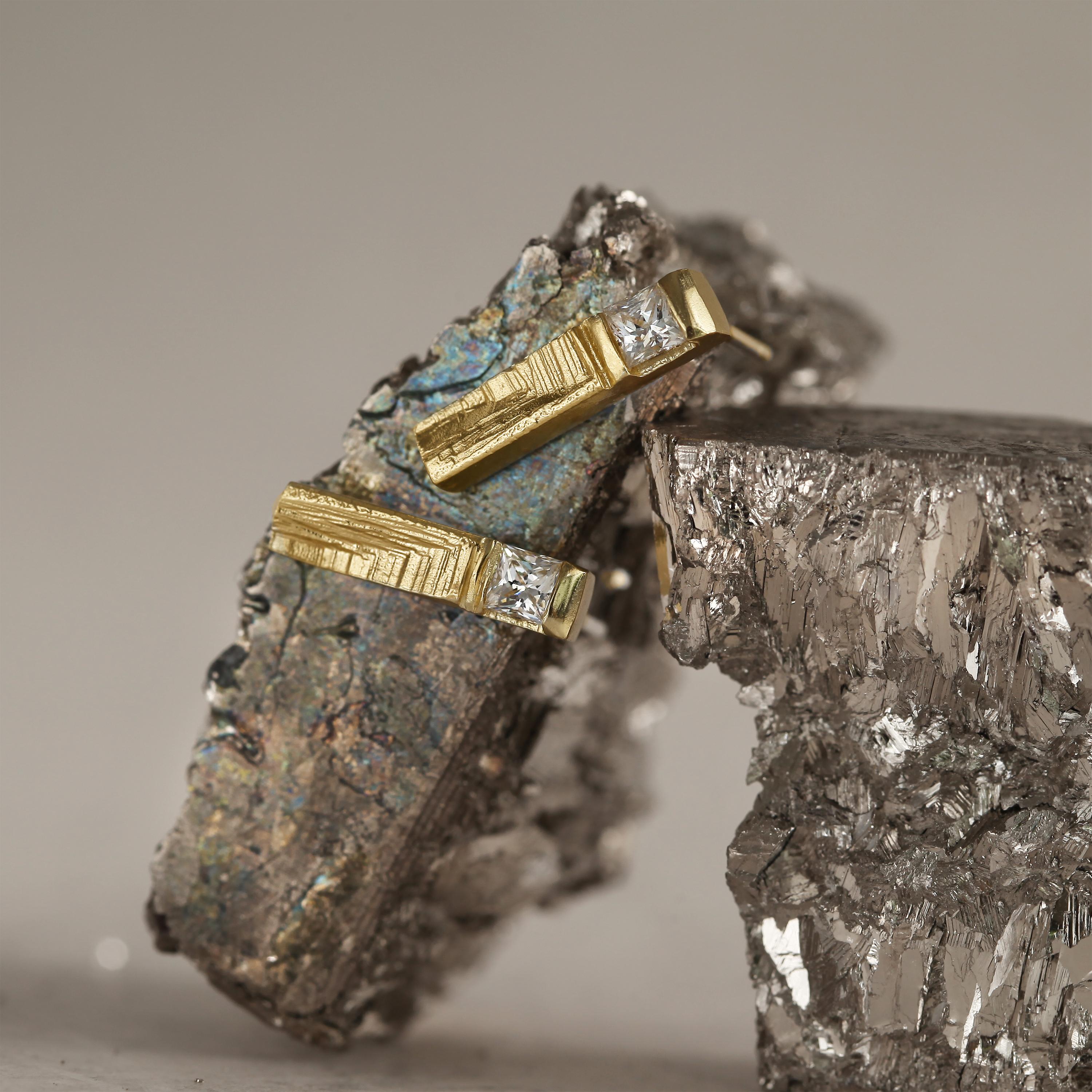 Defined by poised geometry, Lumae earrings in 18-karat gold command attention through the subtle tension between polished planes and carved textures. Princess-cut diamonds catch and fracture light with silent brilliance, while sculpted reliefs evoke