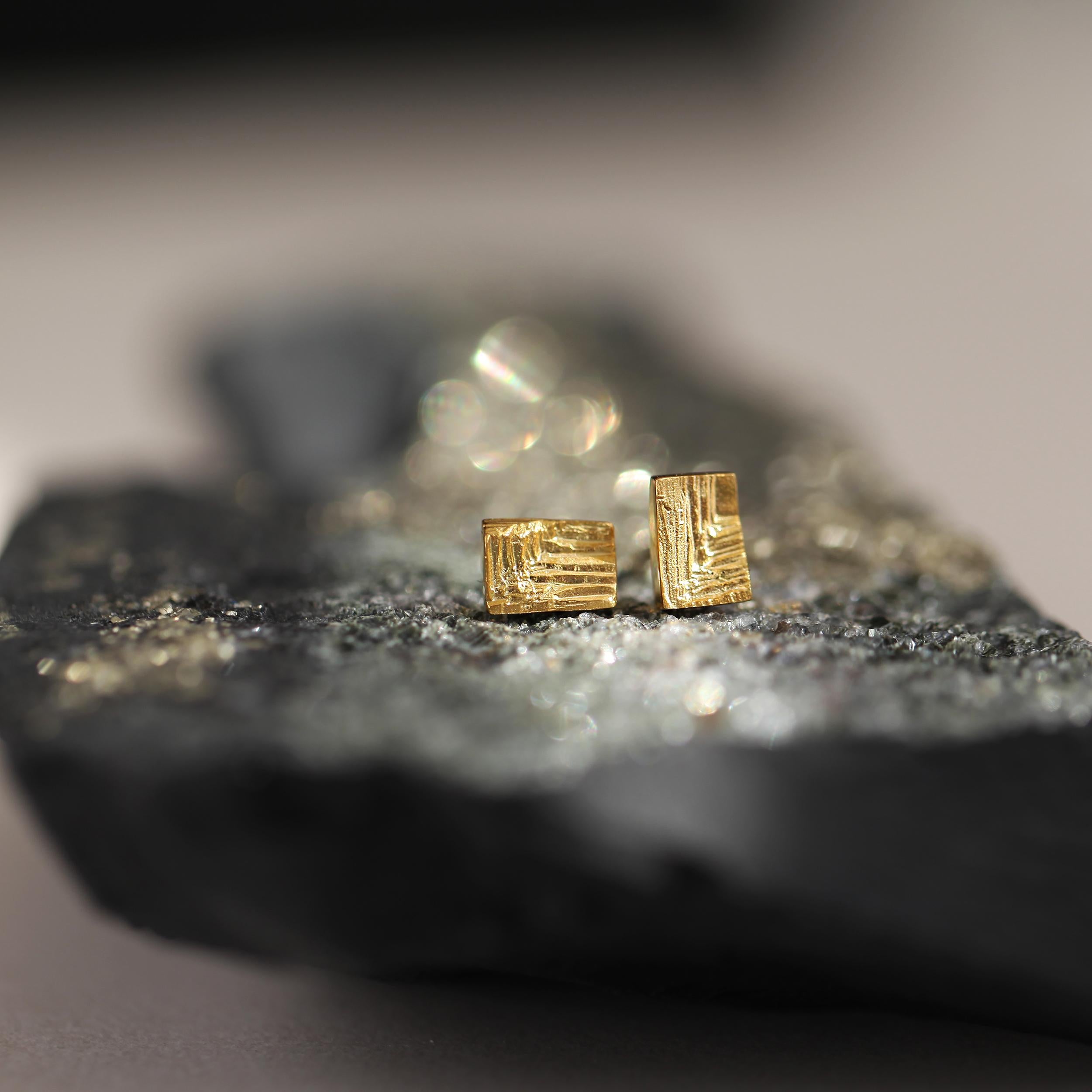 Gli orecchini XYZ Mino, creati in oro riciclato a 18 carati, incarnano una geometria precisa ammorbidita da striature intagliate a mano che invitano a un sottile movimento superficiale. 
Ispirate alla moderna architettura cartesiana e alle