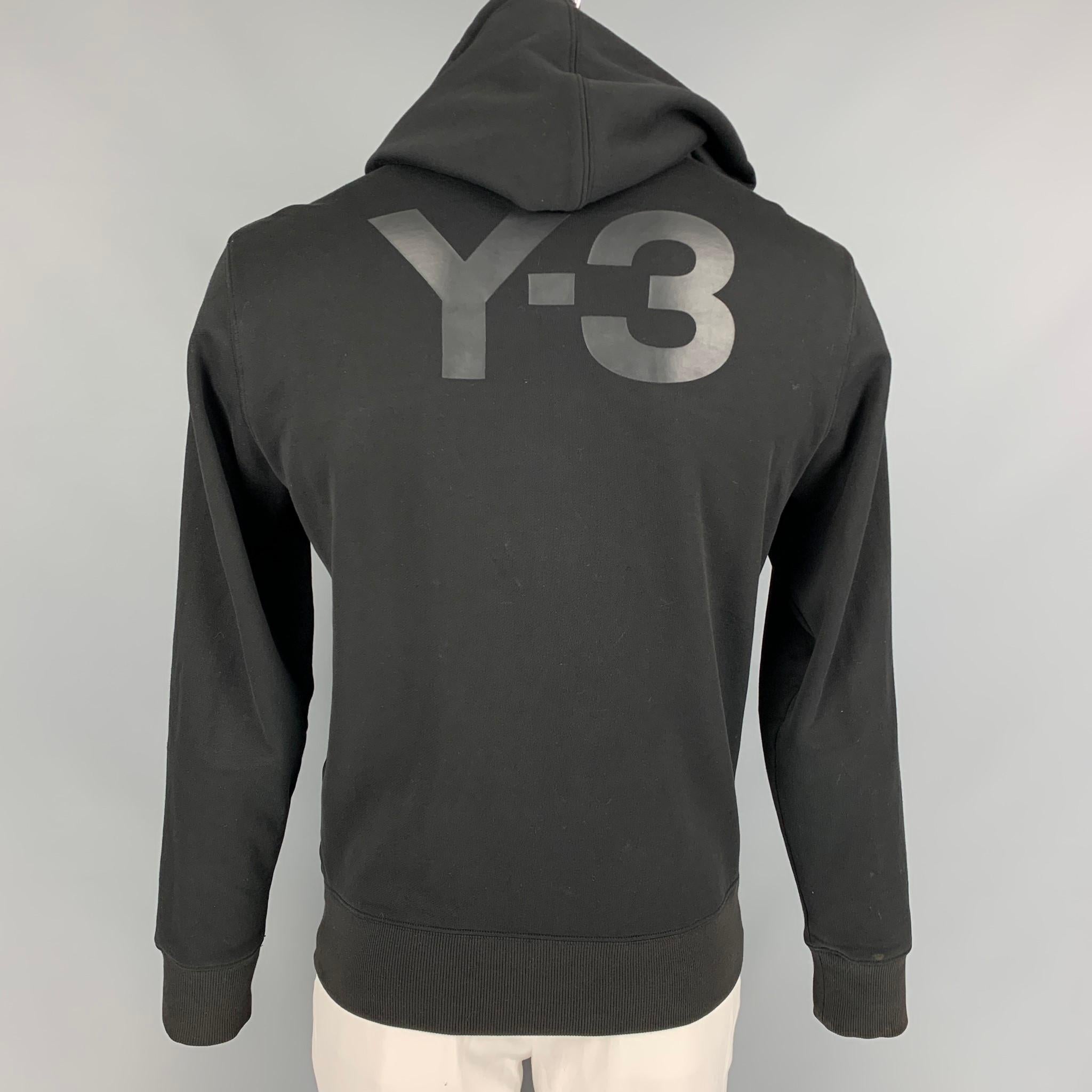 Y-3 by YOHJI YAMAMOTO jacket comes in a black cotton featuring a hooded style, back logo detail, and a full zip closure. 

Very Good Pre-Owned Condition.
Marked: L

Measurements:

Shoulder: 20 in.
Chest: 40 in.
Sleeve: 28 in.
Length: 27 in. 