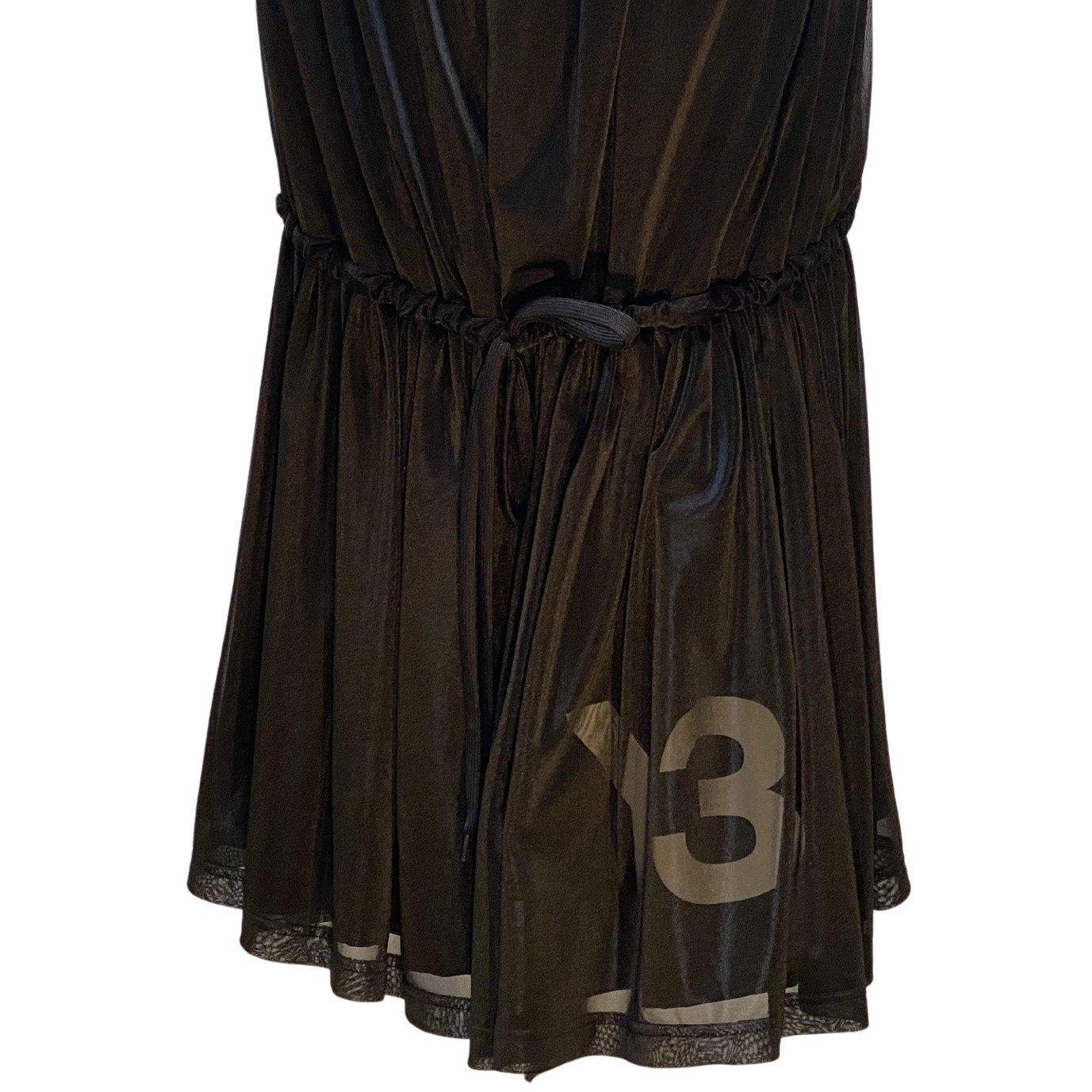 This vintage layered, flounced skirt from Y-3 has an elasticized waist, which allows it to convert to a strapless dress. A drawstring gathers the black fabric at knee-length, or can be tied as a belt if worn as a dress, creating a flowing feminine