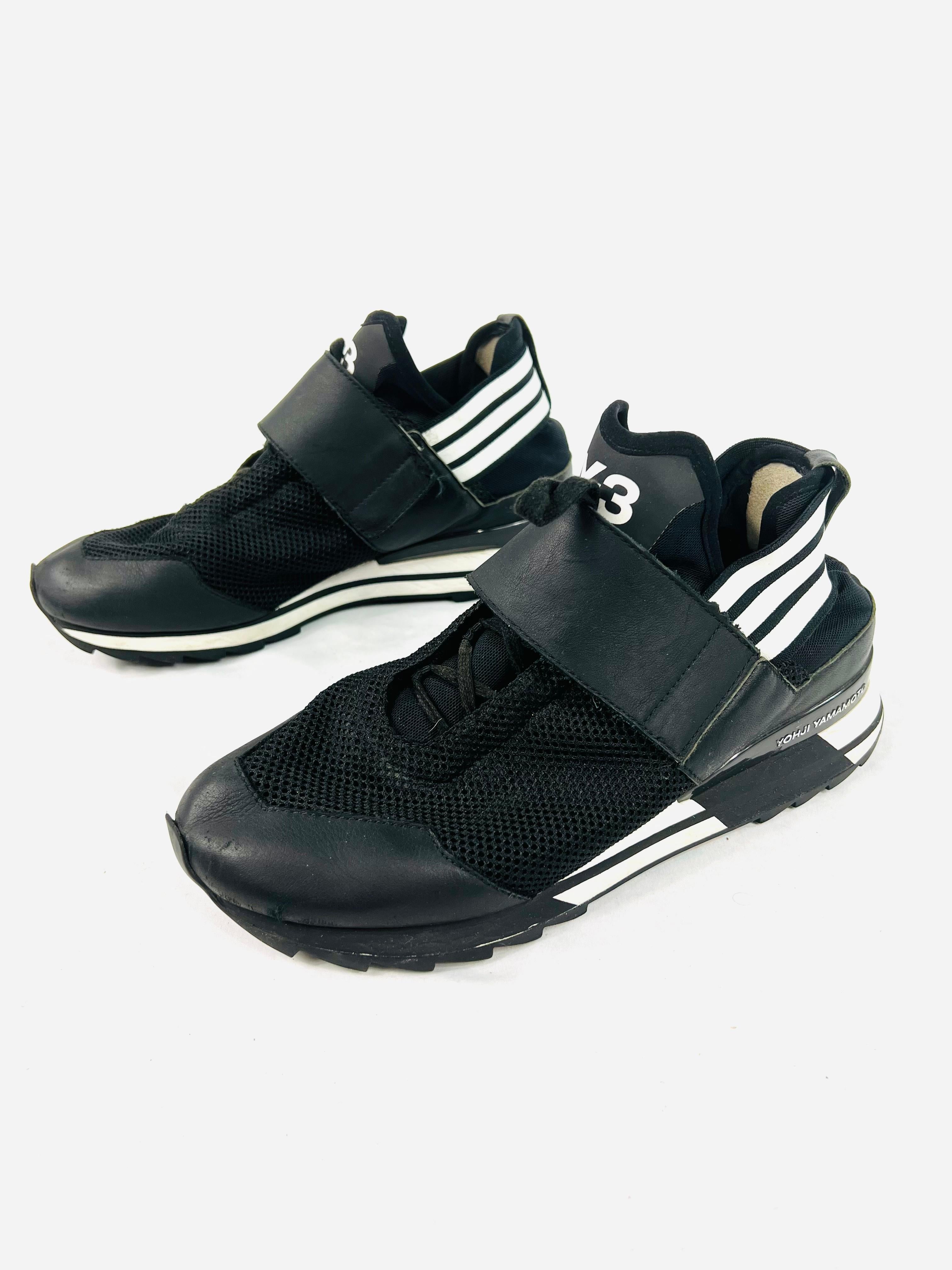 Product details:

The athletic shoes feature black leather and textile, lace fastening and black and white striped detail. 