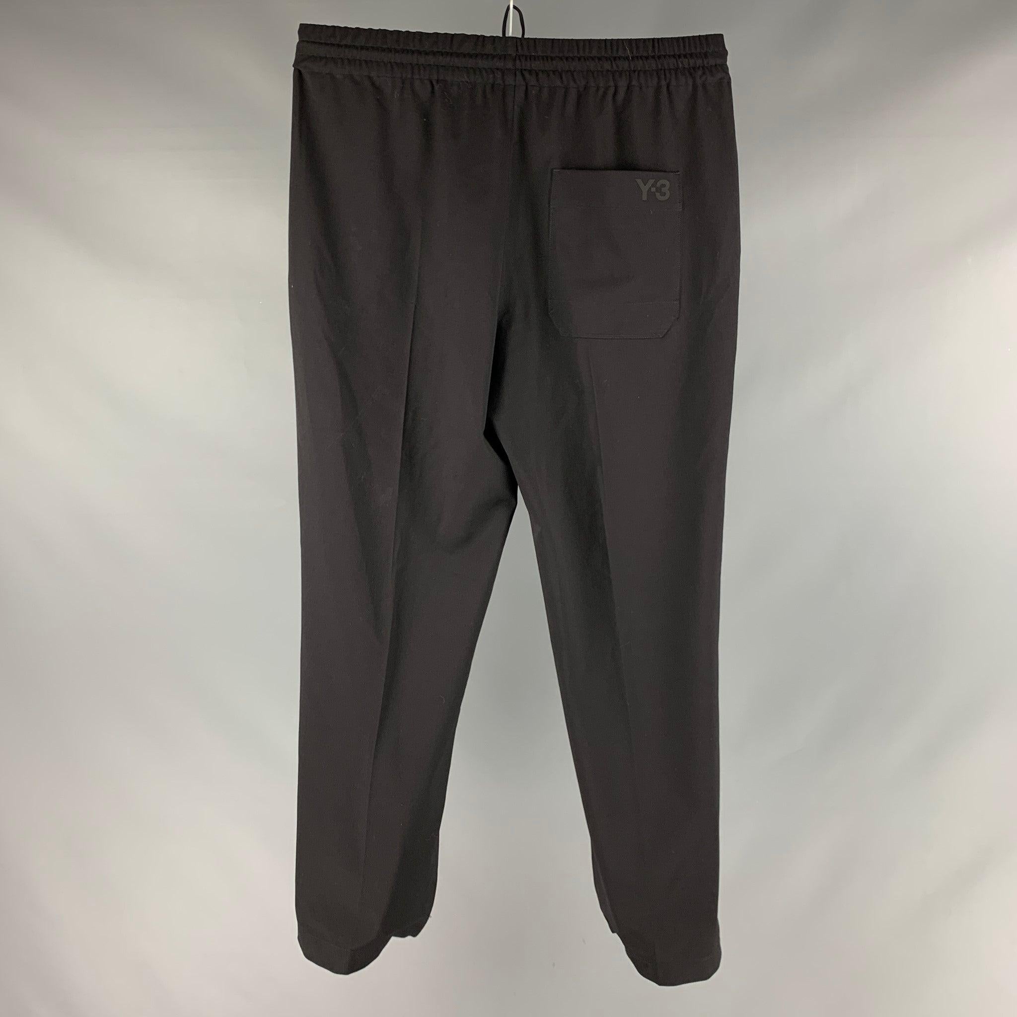 Y-3 by YOHJI YAMAMOTO casual pants comes in a black polyester twill
 featuring a
 logo detail, elastic waistband, drawstring detail, and a zip fly closure.Excellent Pre-Owned Condition. 

Marked:   L 

Measurements: 
  Waist: 35 inches Rise: 12.5