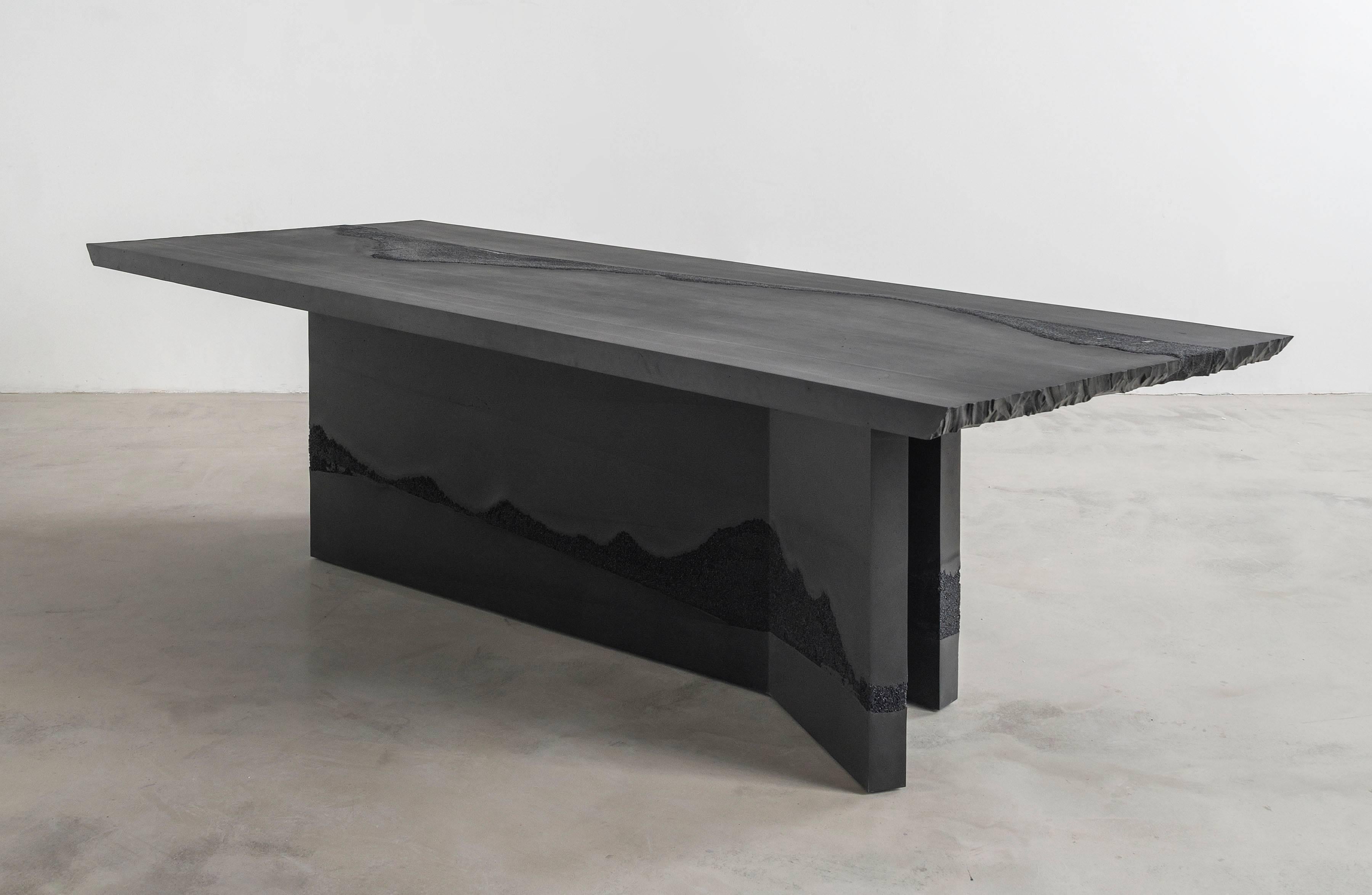 A contrast of smoothness and textured striations, the made-to-order table is cast entirely from hand-dyed cement and silica. Cast in layers, the raw edges are hand-carved in natural undulations to create an effect evocative of scenes of water,