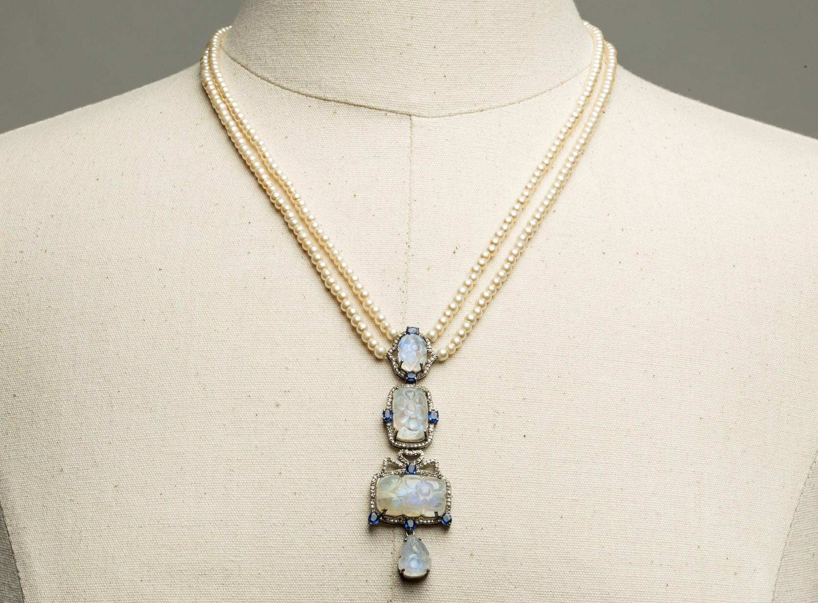A stunning and elegant Y Drop necklace with two lines of pearls with a pendant drop of carved cabochon rainbow moonstones bordered with oval kyanite gemstones and round, brilliant cut diamonds in a pave` setting. The drop itself is 3 inches.  The