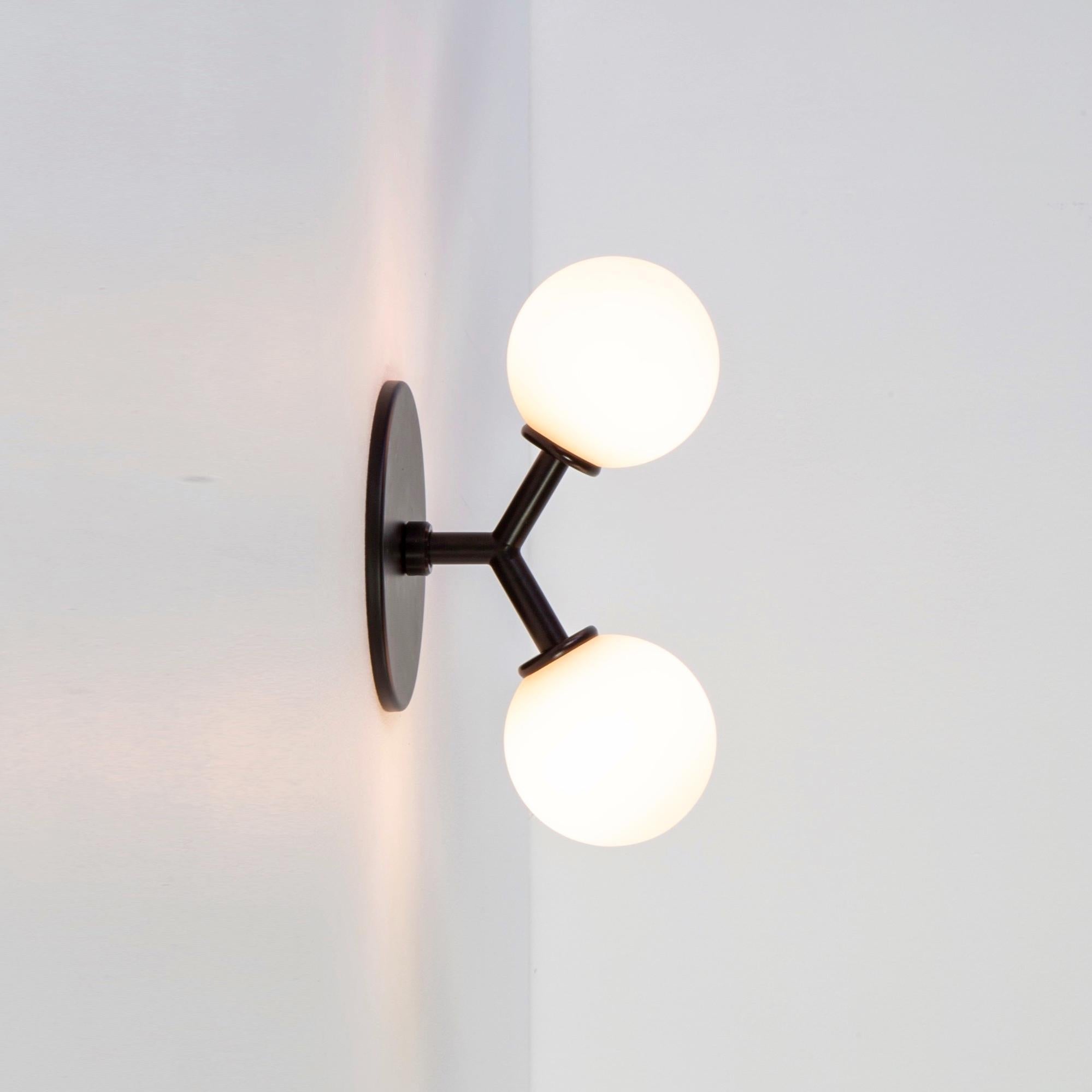 This listing is for 1x Y sconce in black designed and manufactured by Research.Lighting.

Materials: Steel & Glass
Finish: Powder-coated steel 
Electronics: 2x G9 Sockets, 2x 2.5 Watt LED Bulbs (included), 500 Lumens total
UL Listed. Made in the USA.