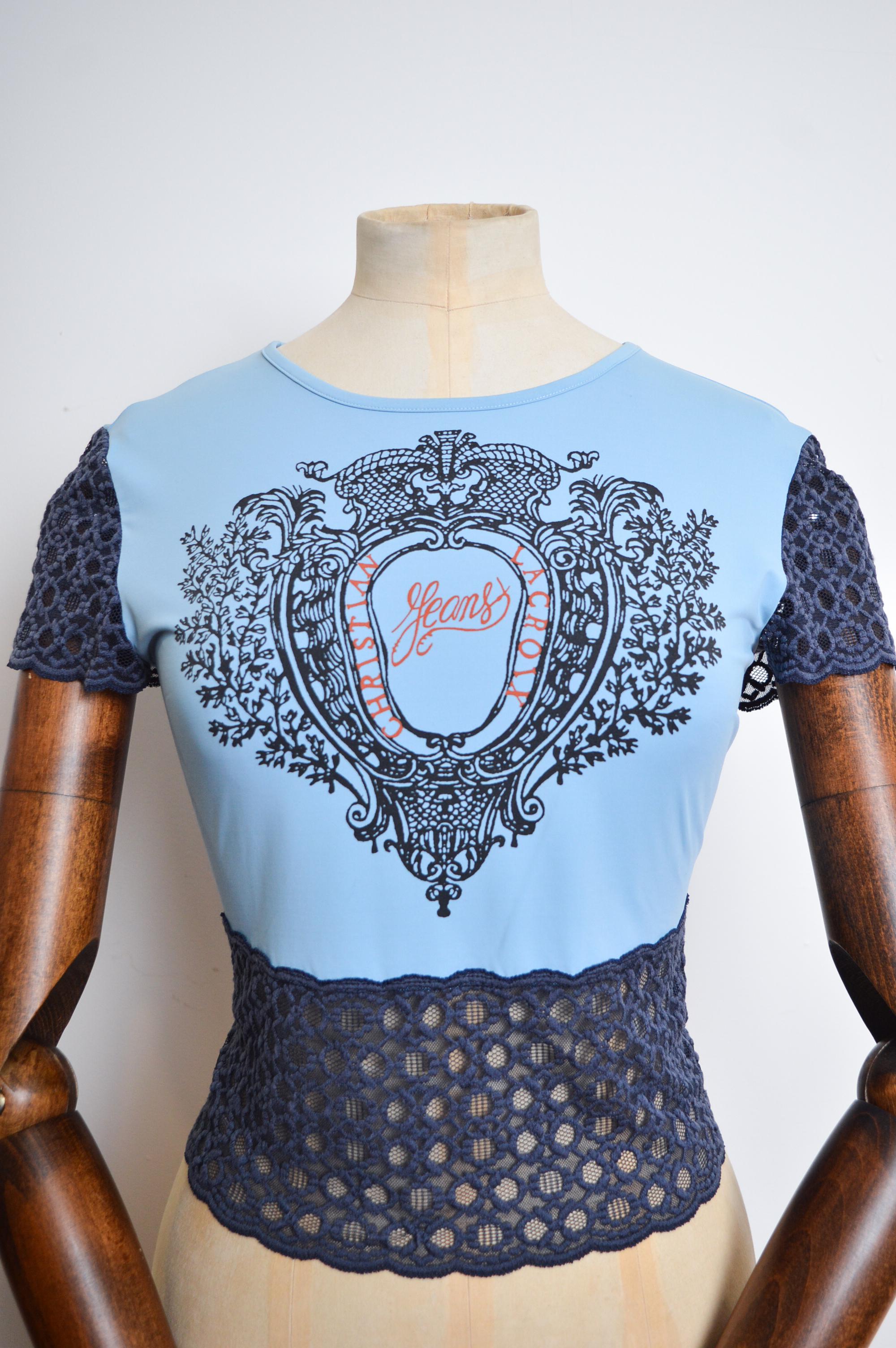 2000's Christian Lacroix baby blue, stretchy, fitted Baby Tee with lace detailed trim and printed Logo front.  

Made in Italy.

Pit to pit - 16