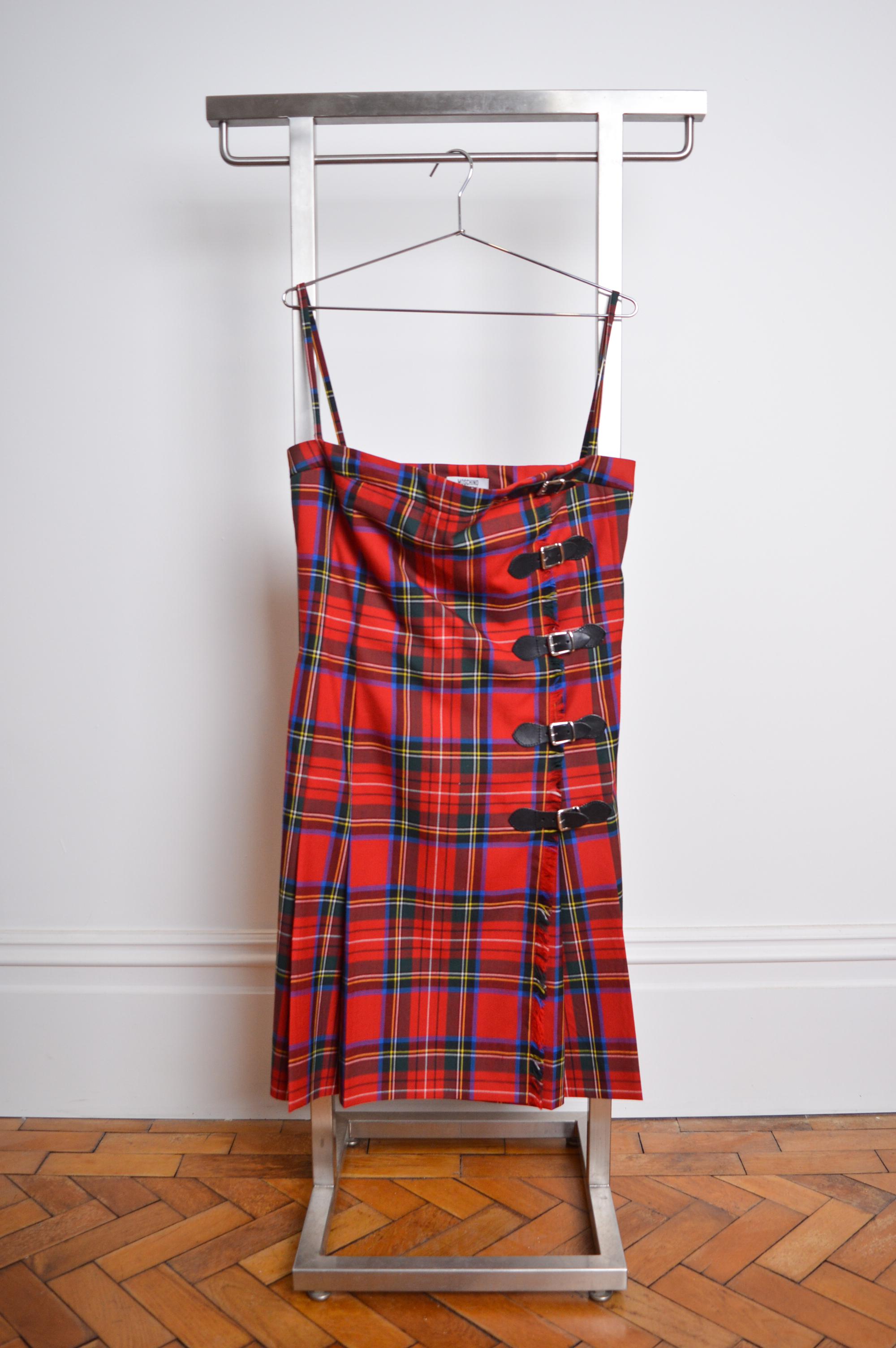 Fun Vintage 2000's MOSCHINO 'Cheap & Chic' Label strapless avant guard Kilt Dress.

This beautiful, Bustier style pleated Kilt Dress is crafted from Red Tartan Wool with Black leather buckle details and inbuilt interior boning construction aswell as