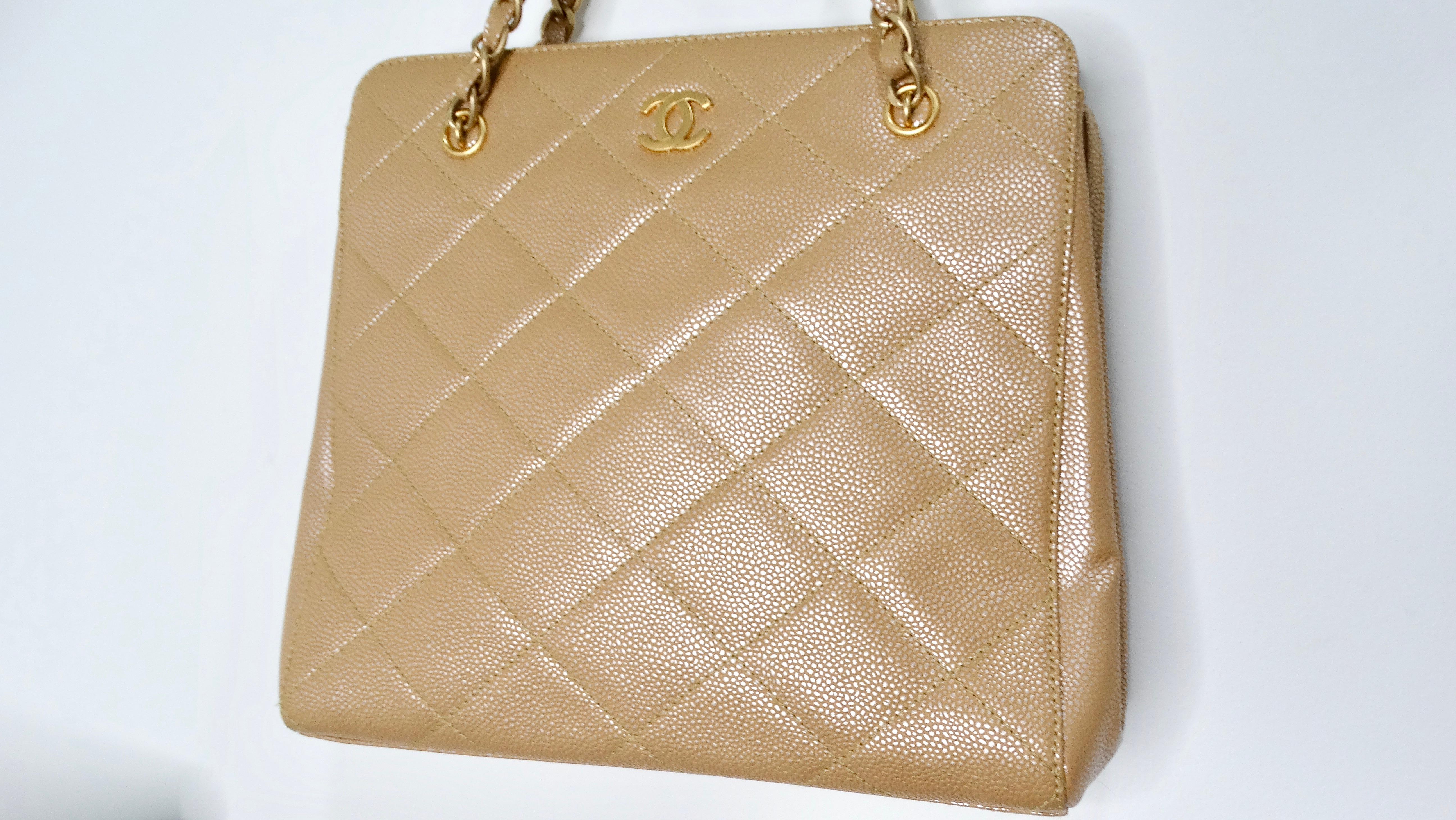 The Y2K Chanel Beige Pearlescent Caviar Leather Handbag is a stunning accessory that effortlessly elevates any outfit. With its luxurious gold-tone hardware and the iconic interlocking CC logo on the front, this handbag captures the essence of high