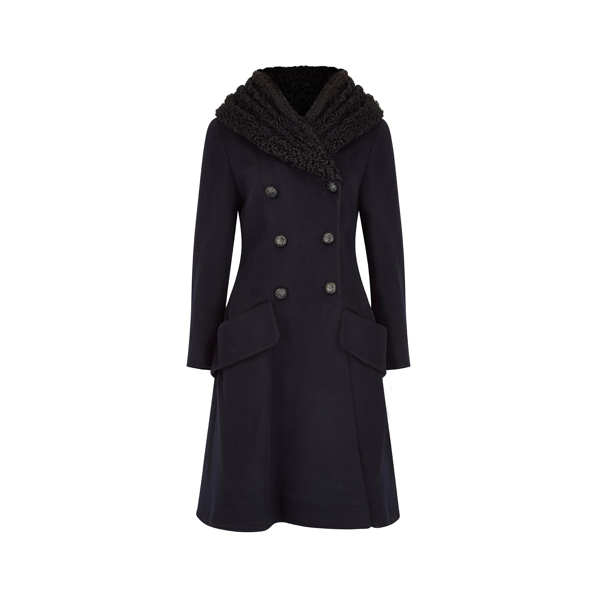 This late 2000s to mid 2010s Chanel coat is made from a luxuriously soft midnight navy cashmere, with a wide black Persian lamb collar. It has a double breasted front fastening, complete with six rounded black diamante buttons, each featuring the
