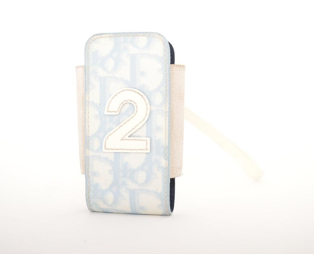 Y2K GALLIANO-era Dior flip phone case, in baby blue Trotter print vinyl, with elasticated sides and wristlet strap. 
 
Features;
Single compartment
Iconic 'Trotter' vinyl exterior with number '2' applique
MADE IN ITALY
SERIAL NUMBER '00-BM-0025'

