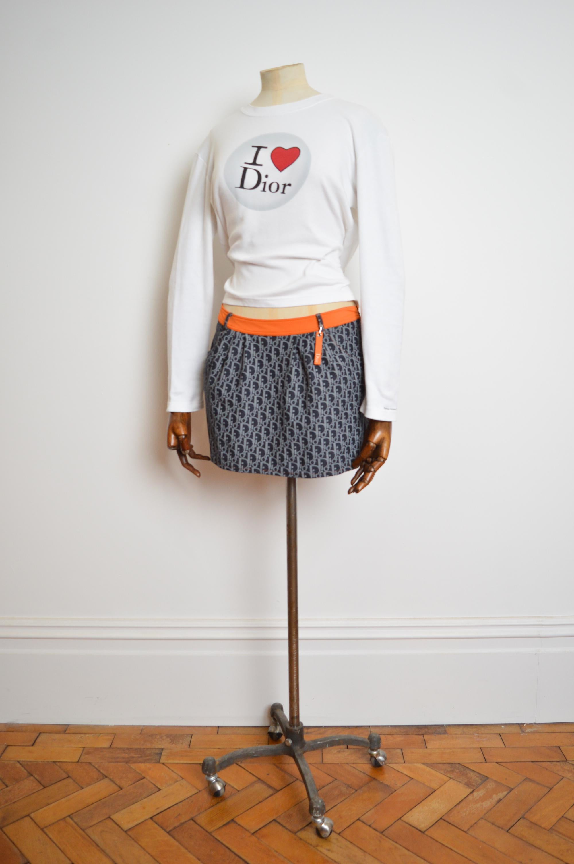 2000's Christian Dior By John Galliano blue & orange trotter print low waisted monogram mini skirt from the iconic 'Remove before flight' Collection.
Made in Italy.
Waistband (worn on the hip); 30”
Length ; 14” 
Recommended Size Small / UK
