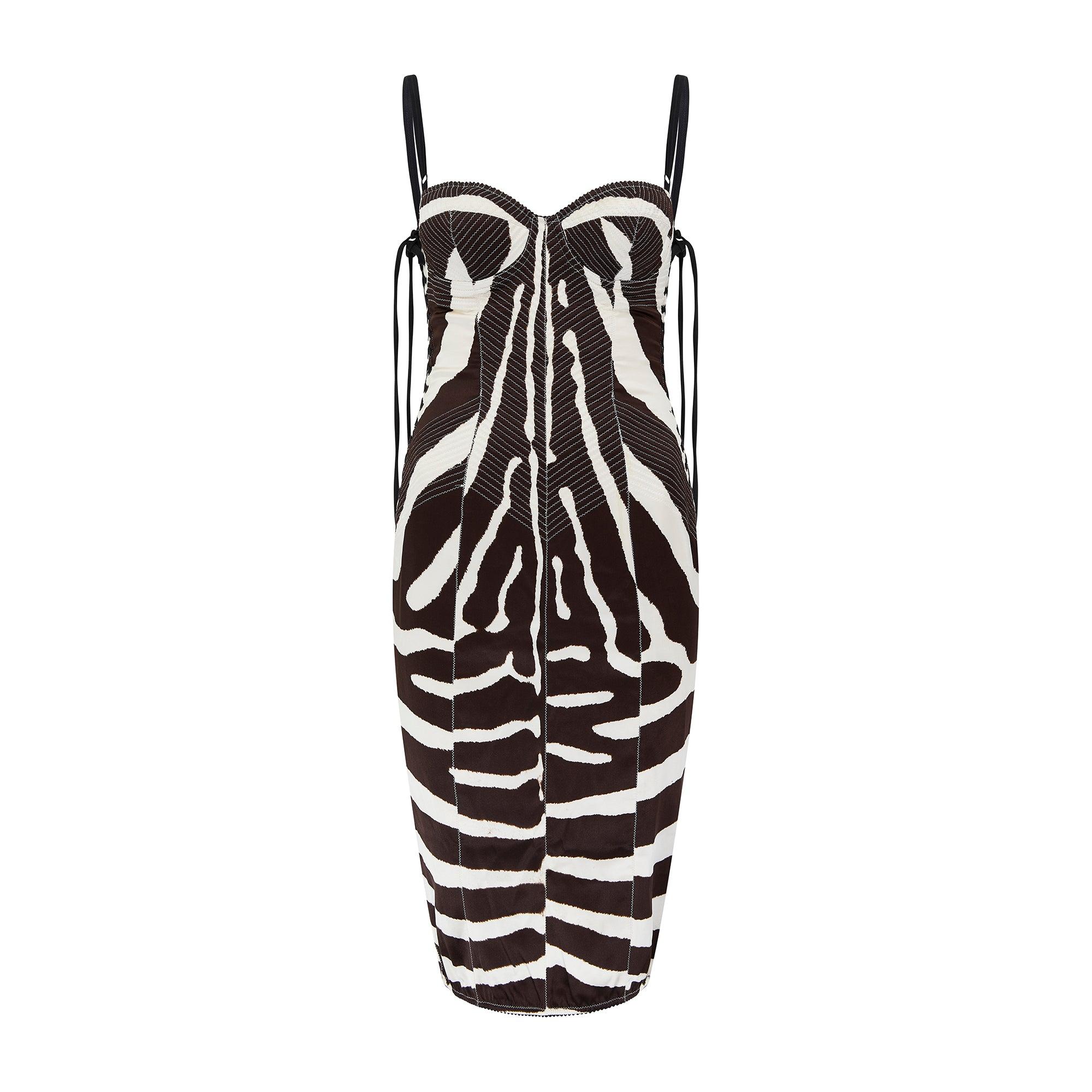 This dress is from Dolce & Gabbana's highly glamorous main line circa 2003. Flaunting many of the fashion house's beloved signature details, we love the underwear-as-outerwear design and sensuous lace-up sides. Tailored from smooth silk with a hint