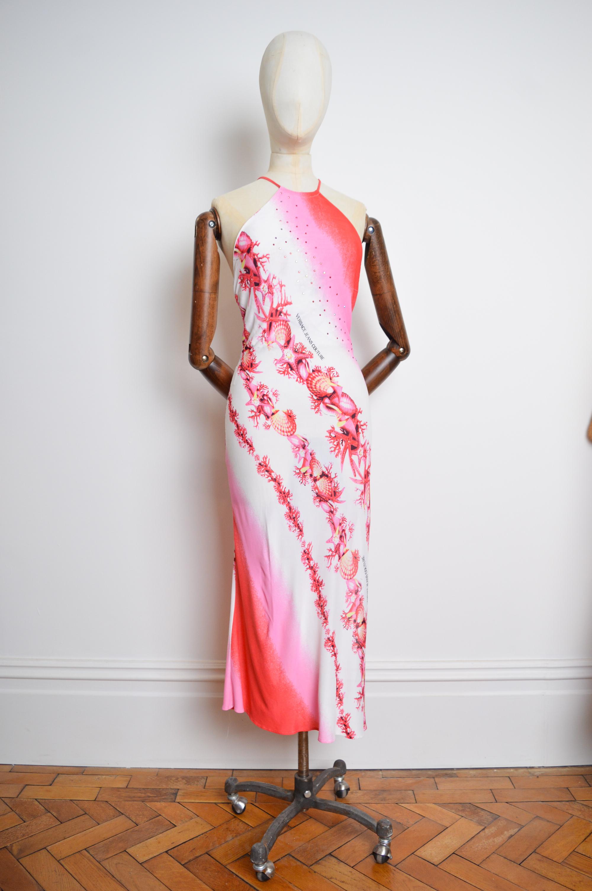 Y2k Vintage Donatella era Versace Dress in a fantasy Pink Ombré coloured sea shell print with Diamonté detailed embellishments !

This mid calf length, backless Dress screams 2000's ! It is made from a stretchy rayon material with a concealed zip up