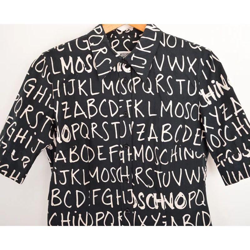 Extremely iconic Vintage 2000's Moschino 'Alphabet' pattern shirt in the black and white colour way with ABC print all over. 

MADE IN ITALY !

Features:
Central line button fasten
Ladies fit
Elbow length Short Sleeves
Iconic ABC Print

96% Cotton /