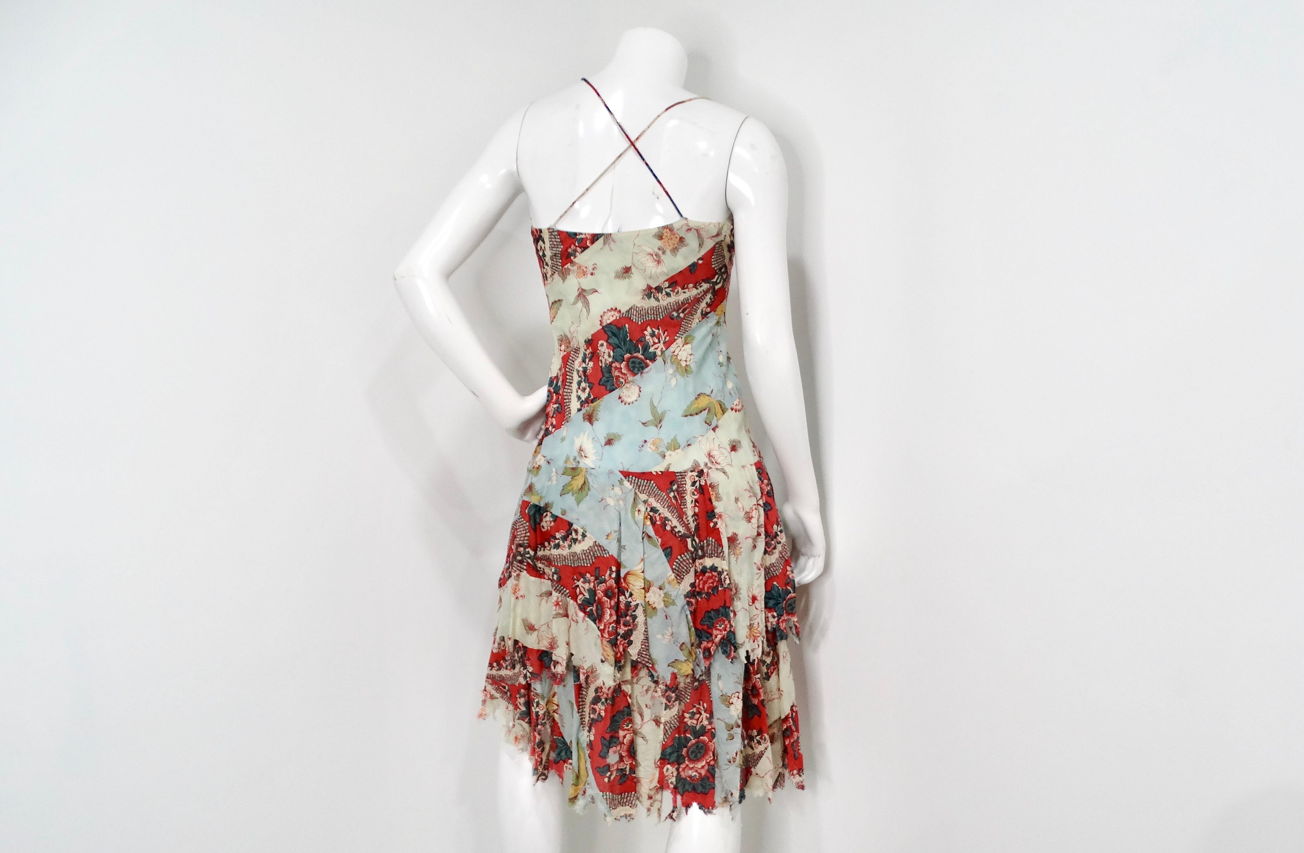 The Y2K Ralph Lauren Floral Multicolor Print Distressed Cotton Sleeveless Midi Dress encapsulates the vibrant spirit of the early 2000s with its layered, patchwork floral design. The dress features a rich tapestry of colors and prints that provide a
