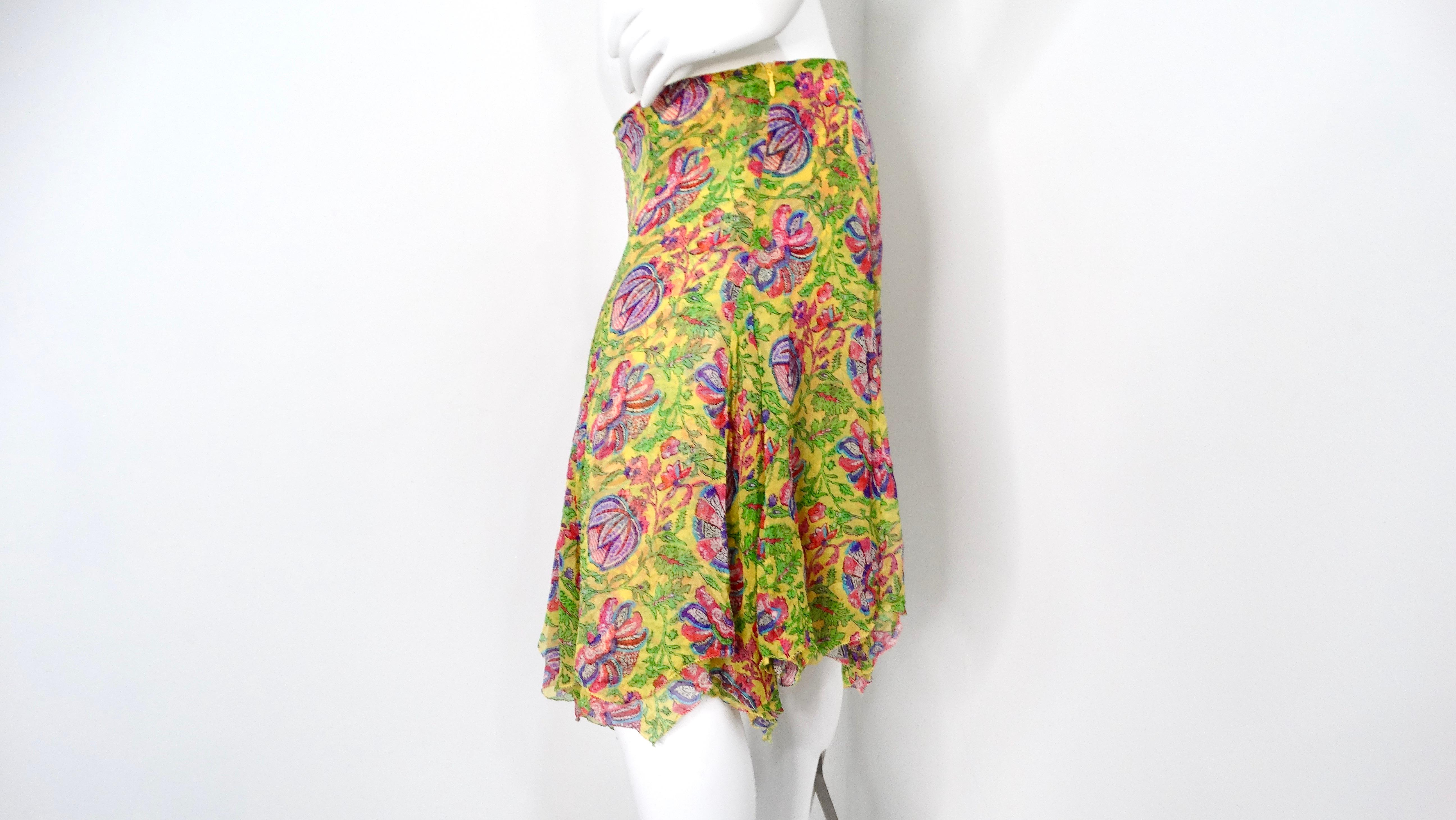 The Y2K Ralph Lauren Silk Yellow Floral Print Skirt is a stunning piece that epitomizes the vibrant spirit of early 2000s fashion. Crafted from luxurious silk, this skirt features a cheerful yellow base adorned with a vibrant floral print, bringing