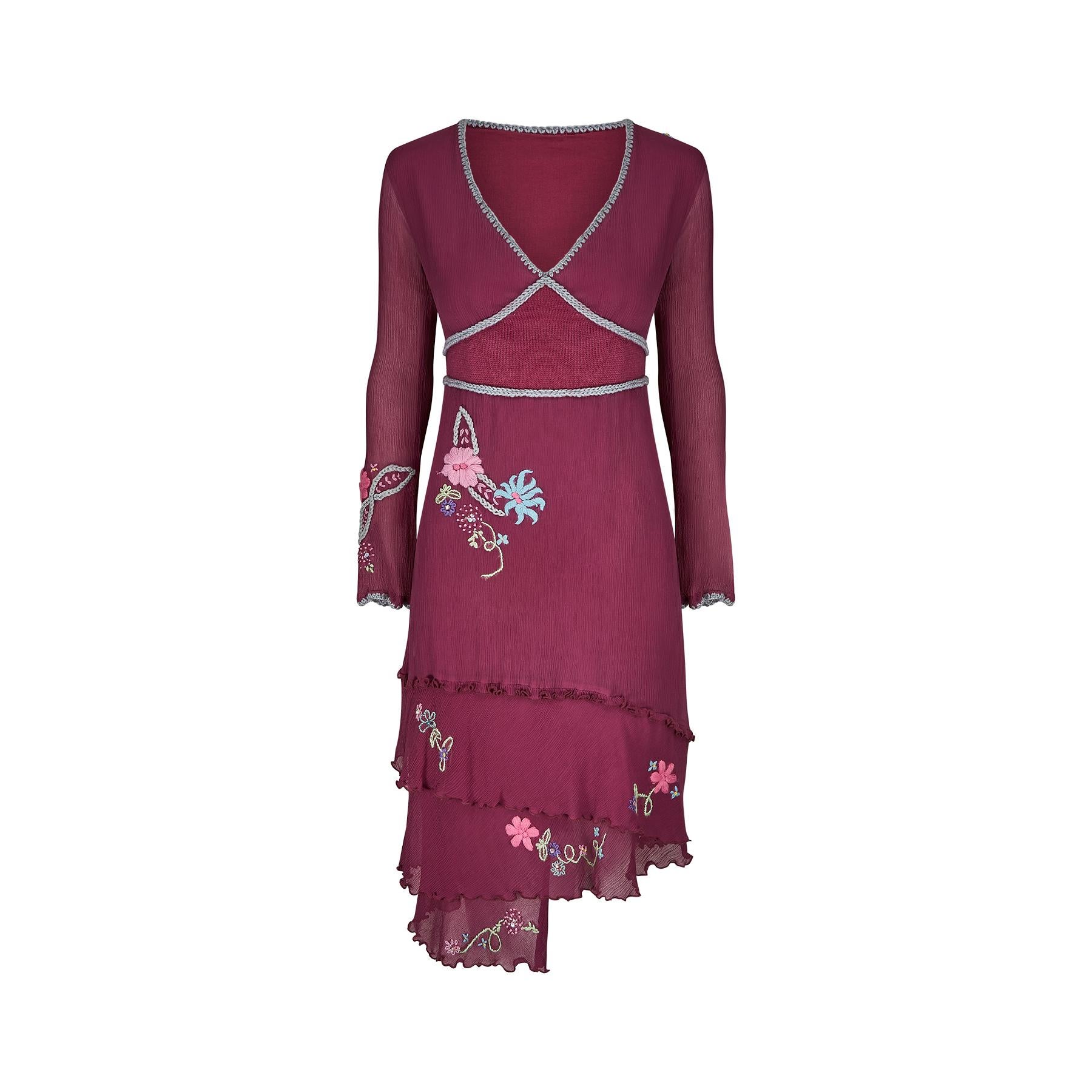 This is a very quirky and interesting premier boutique dress purchased by our client for a boho themed wedding in 2000. The main material is silk crepe in a pink - purple shade which is then embellished with knitted pastel coloured floral motifs and