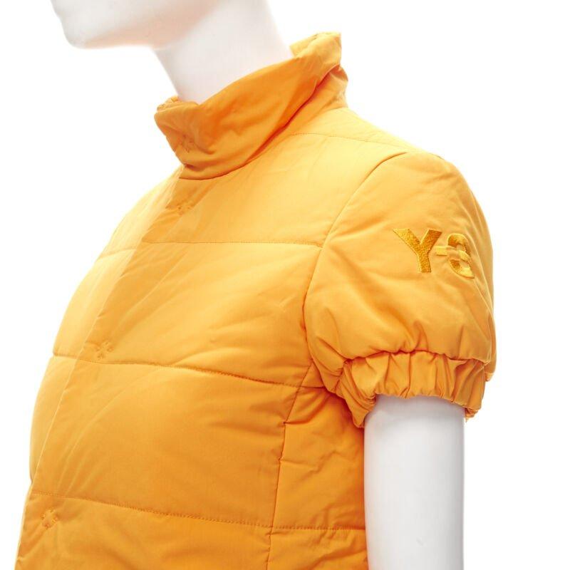 Y3 YOHJI YAMAMOTO ADIDAS orange padded puffer top XS
Reference: ANWU/A00682
Brand: Y3
Designer: Yohji Yamamoto
Material: Nylon
Color: Orange
Pattern: Solid
Closure: Snap Buttons
Extra Details: Y3 logo embroidered on left sleeve. Front concealed zip