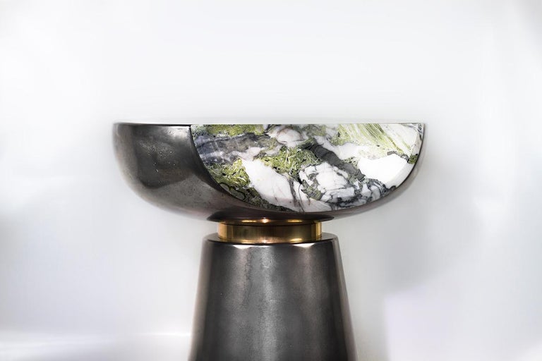 Handcrafted sculptural side table cast in liquid aluminum with marble face and polished brass collar. Made to order. Clients can choose options for metal finish and marble face.