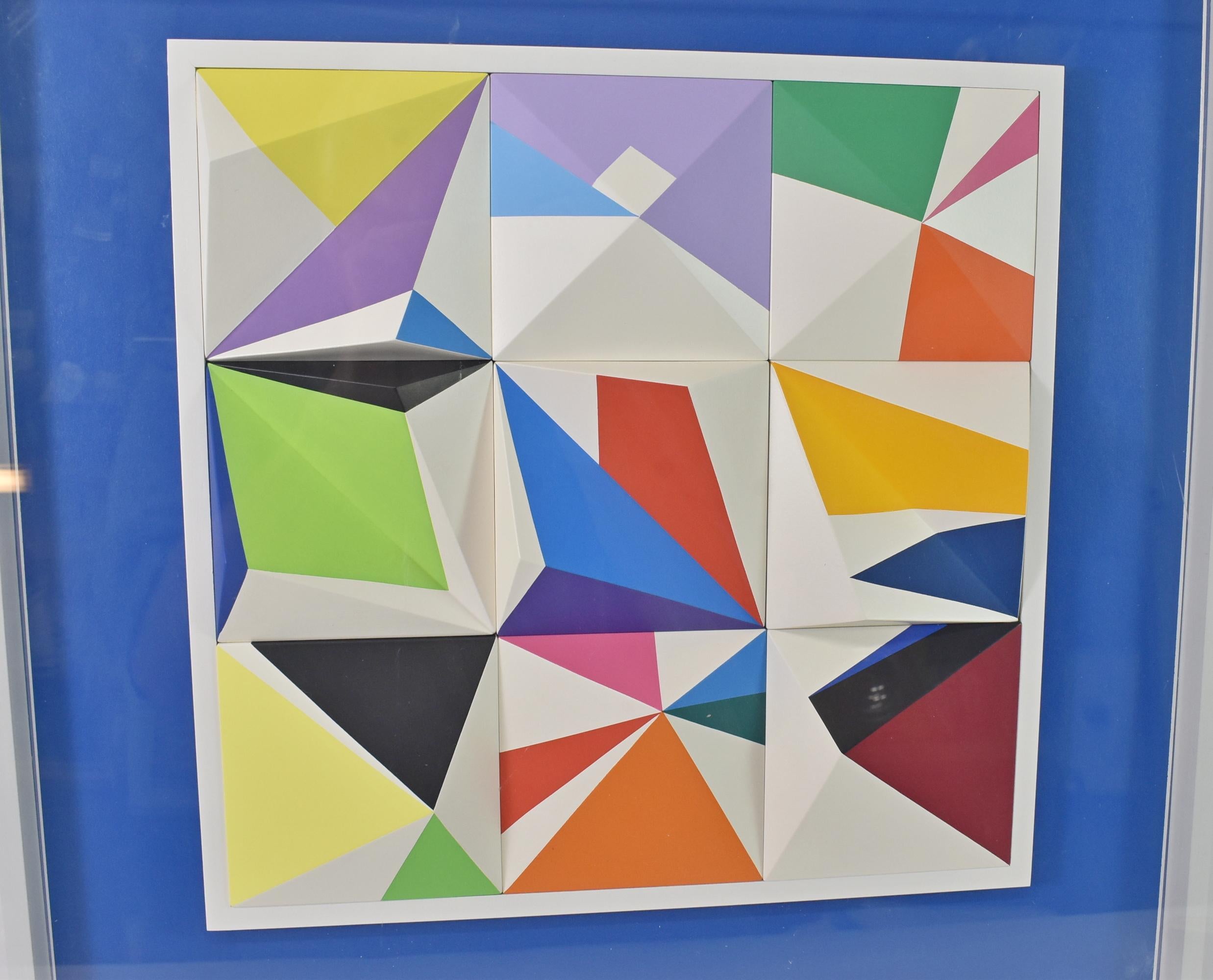 Yaacov Agam, Andromeda 1985, Color Screen Print on 3-dimensional PVC. Modular spacegraph of 3-dimensonial work on folded PVC pyramidal forms with color screen print work mounted on a blue background. From an edition of 99 in a removable acrylic